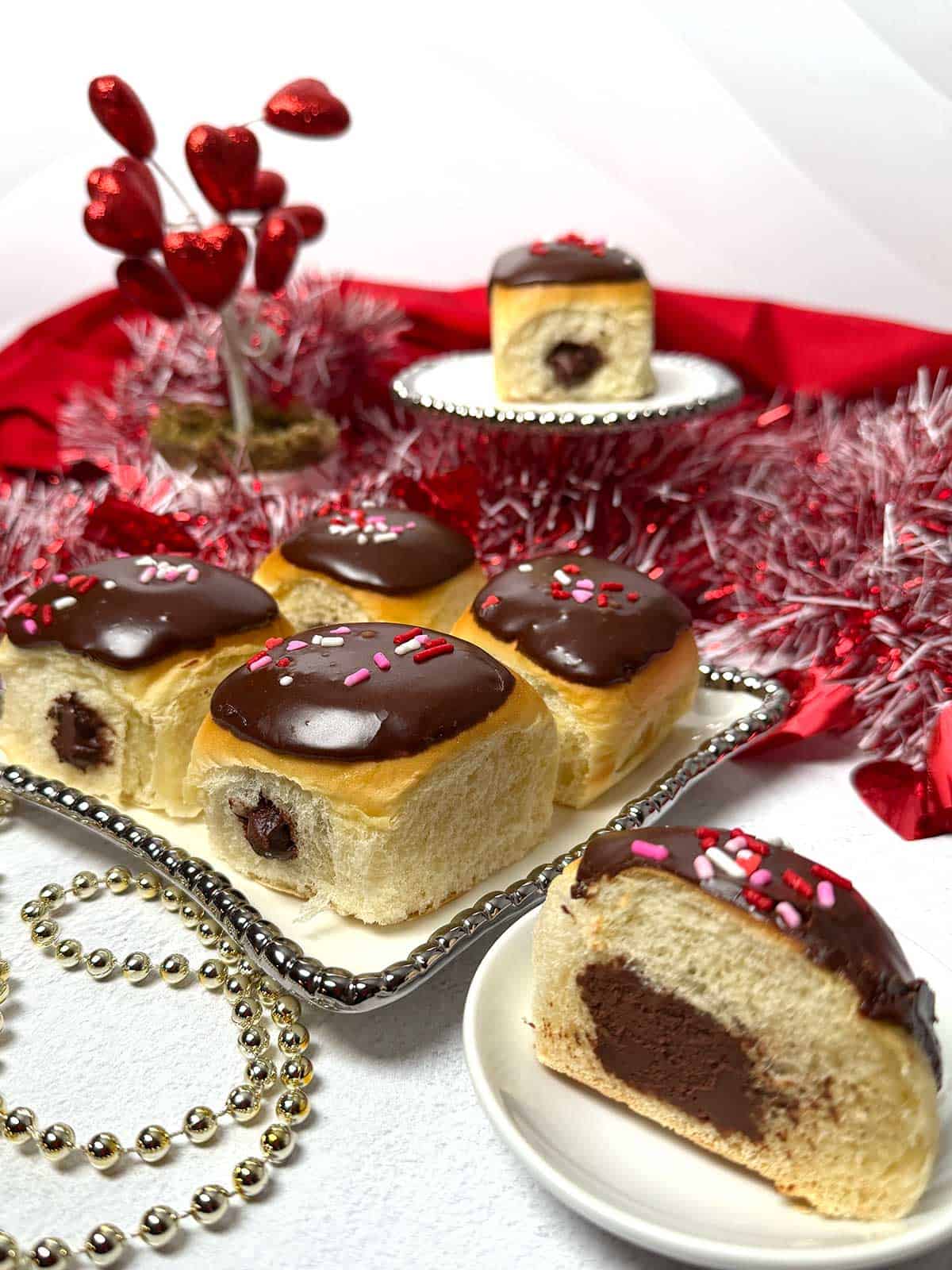 Chocolate filled rolls with one cut in half.