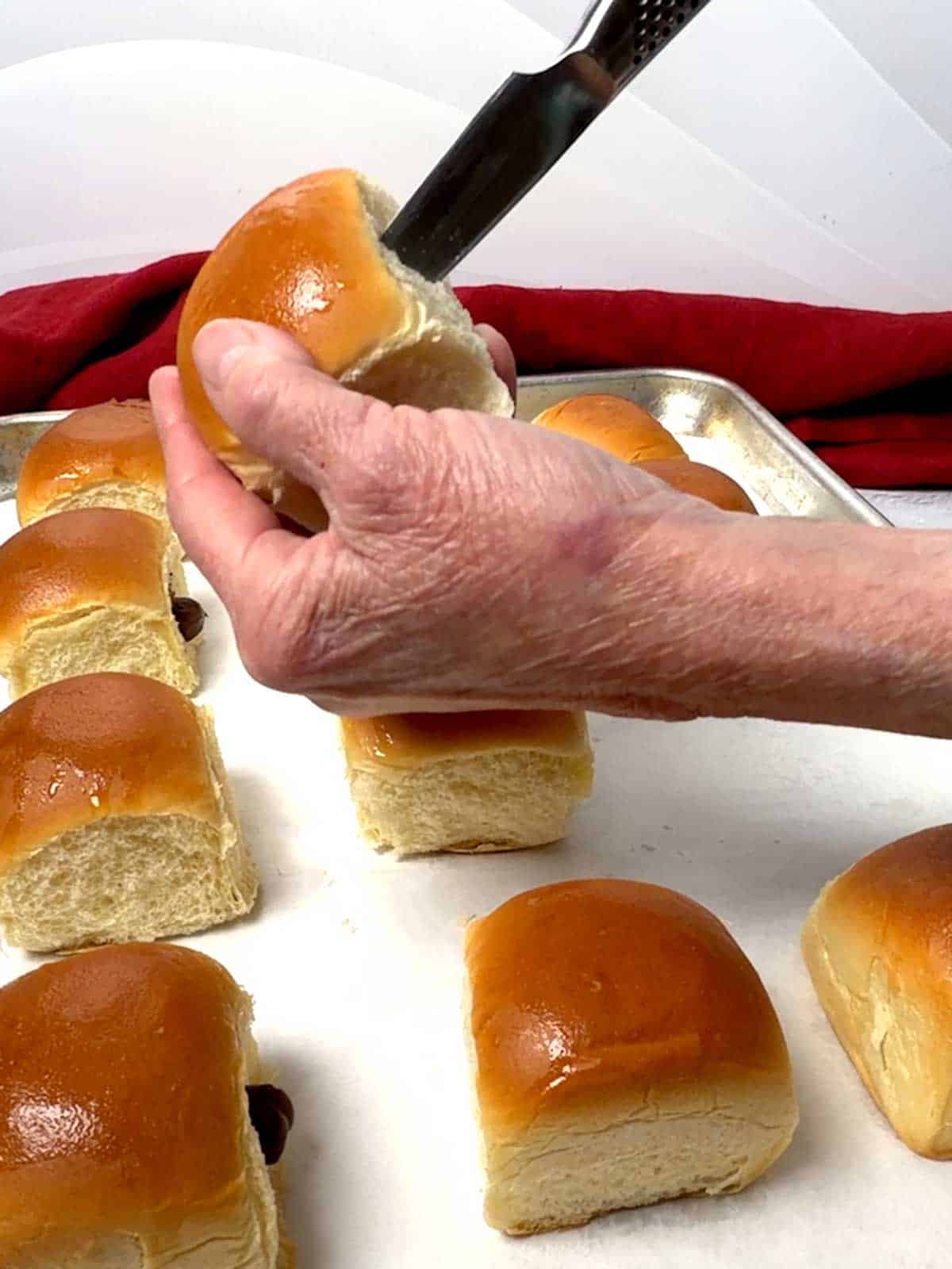 Cutting a pocket in the side of a King's Hawaiian Roll.