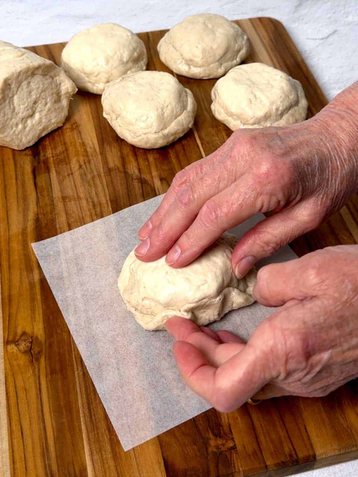Pinching the bottom piece of dough against the top piece.
