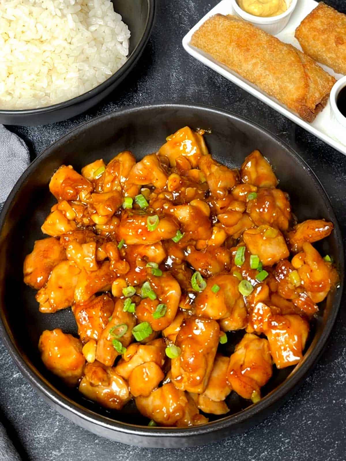 Kung Pao chicken with rice and egg rolls.