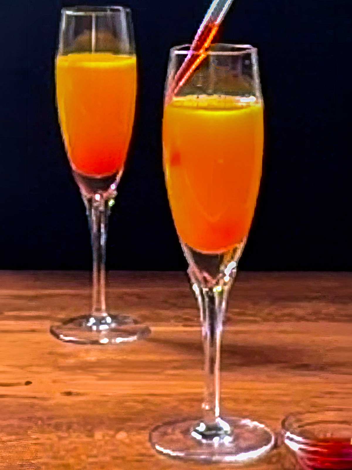 Adding grenadine to the sparkling drink.