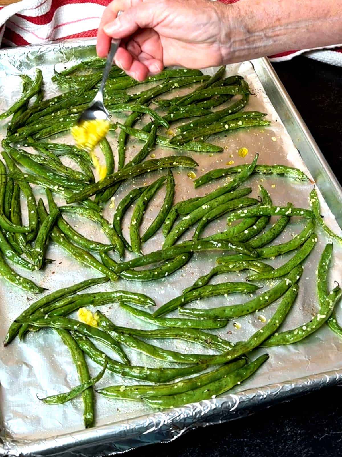 Adding garlic to the green beans.