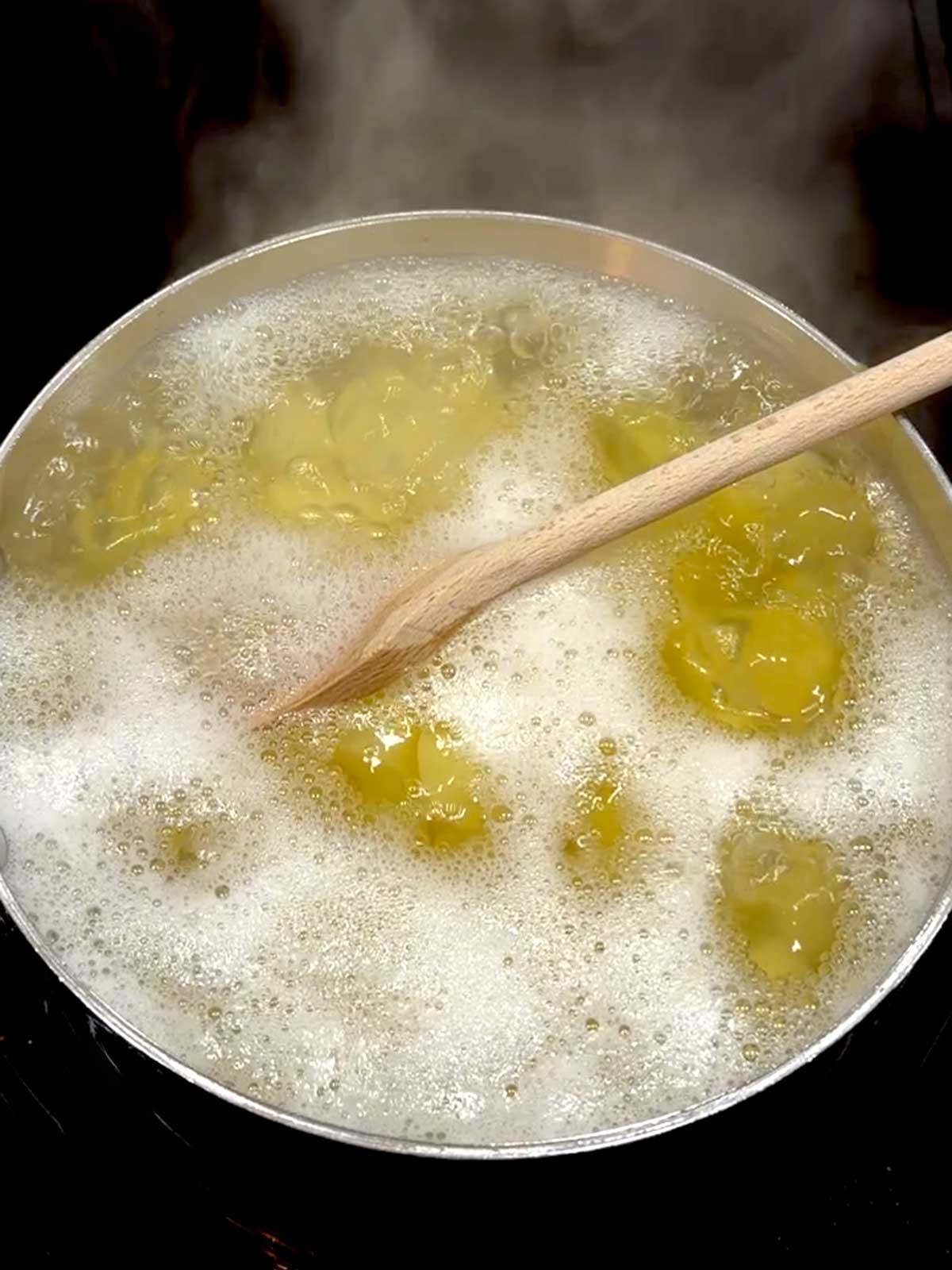 Boiling the potatoes in the saucepan.