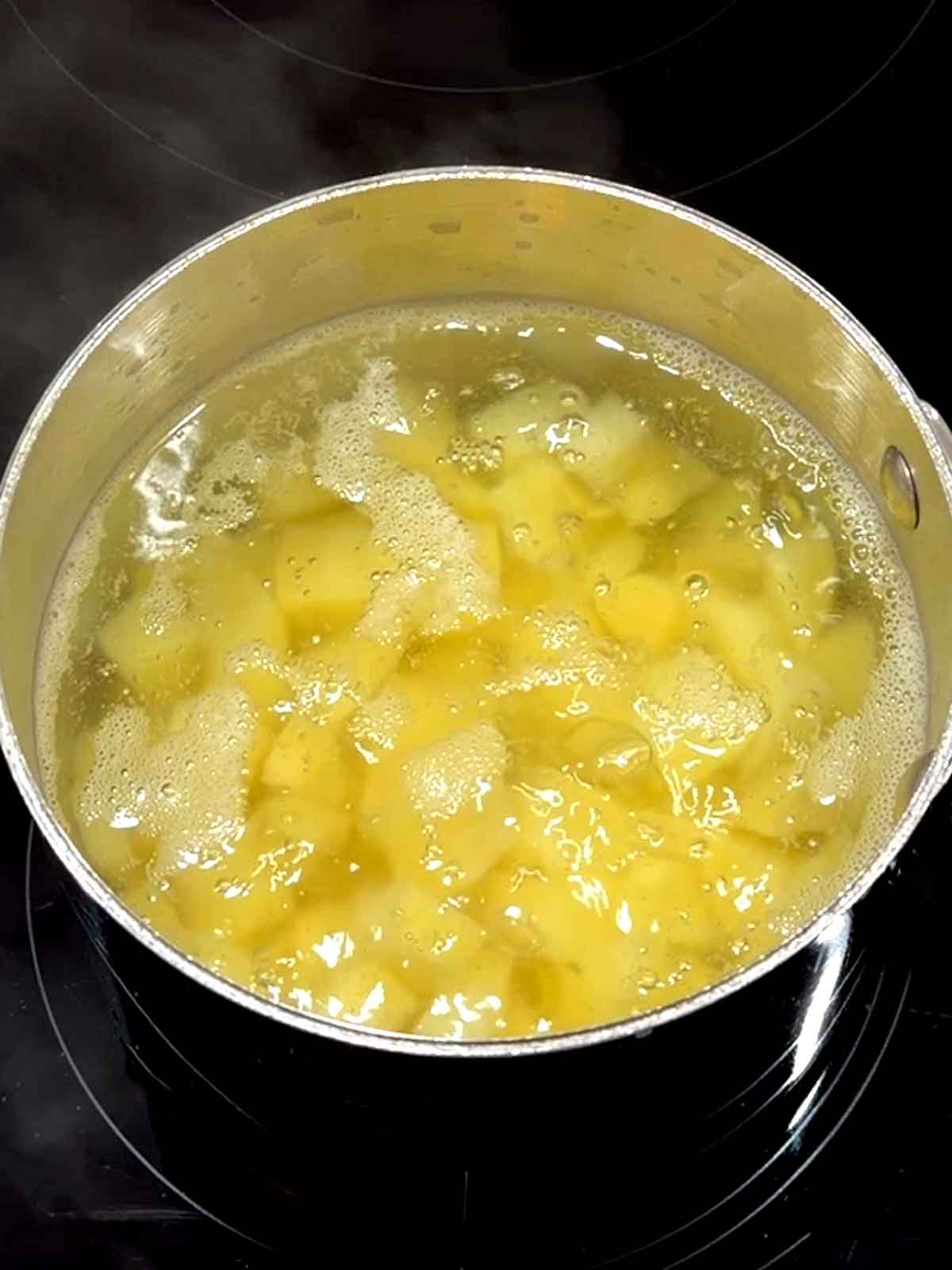 Cooking the potatoes in a small saucepan.