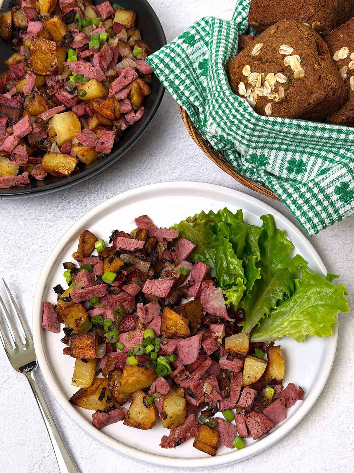 Corned beef hash with green salad and rolls.