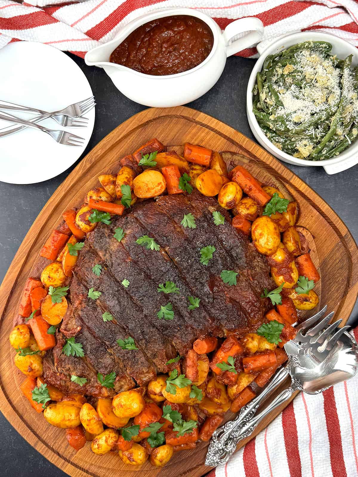 serving sliced brisket with roasted vegetables