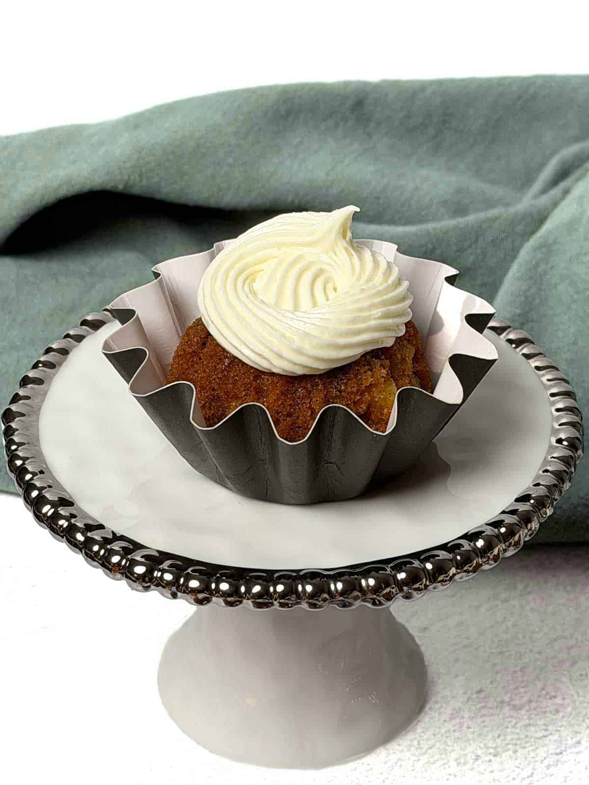 Mini carrot bundt cake with swirled cream cheese frosting.