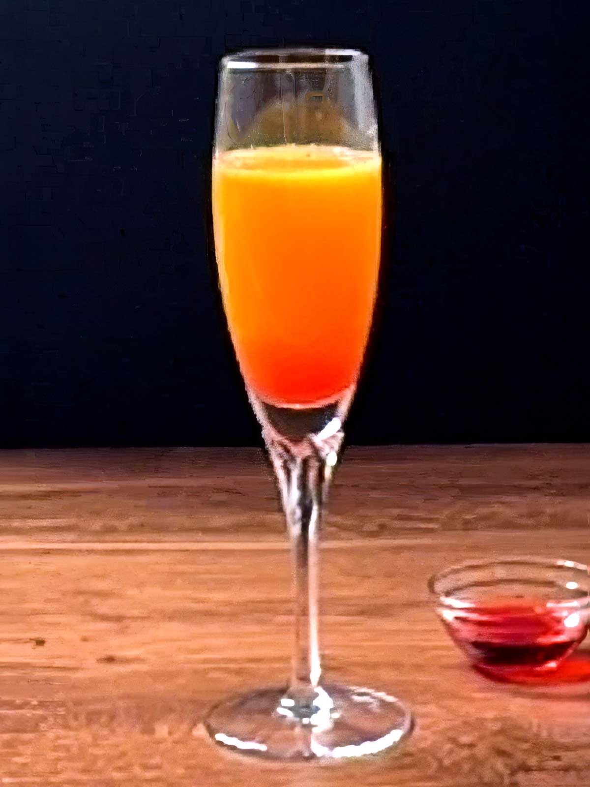 Easter Sunrise Sparkler with a small bowl of grenadine.