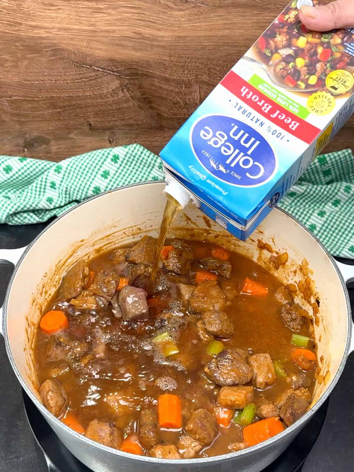pouring beef broth into pot