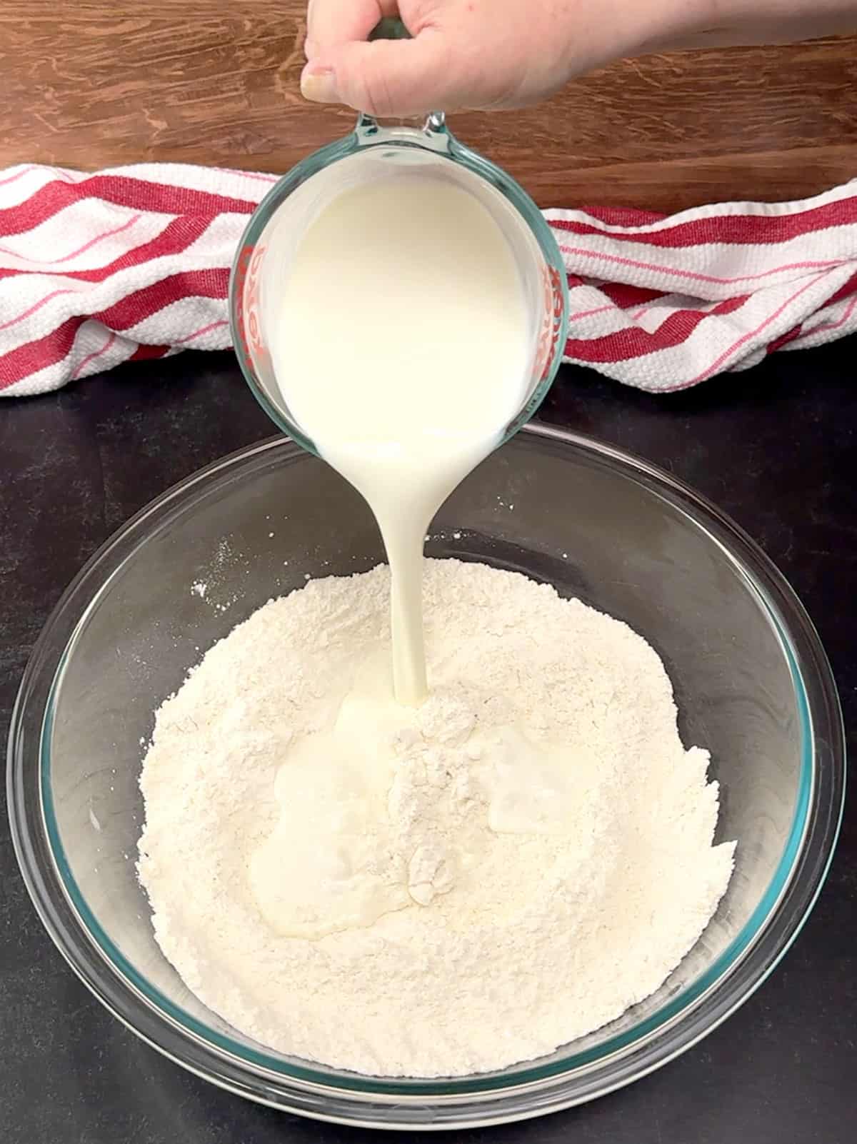 pouring buttermilk into the dry ingredients