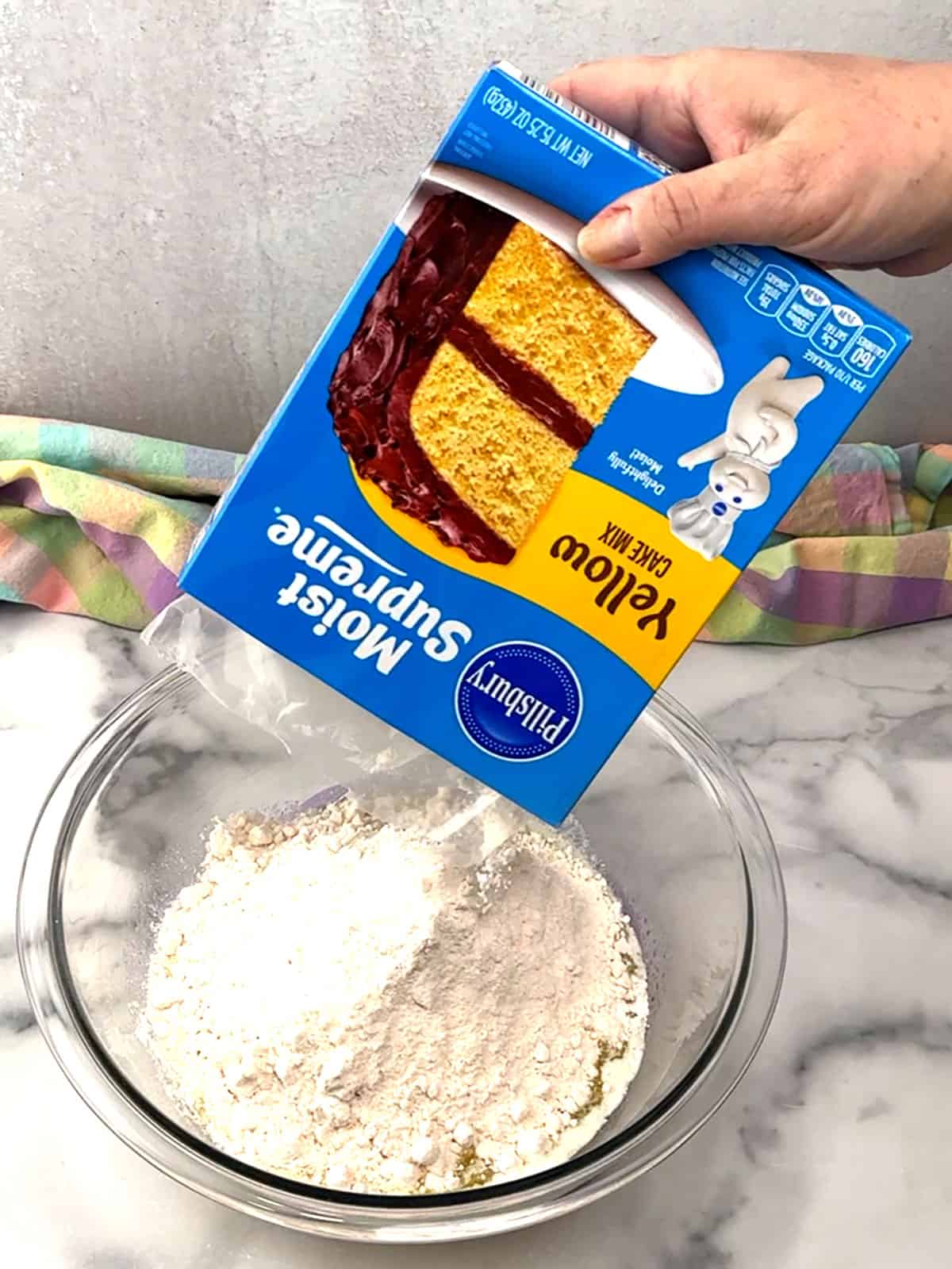 adding cake mix to melted butter for bottom layer