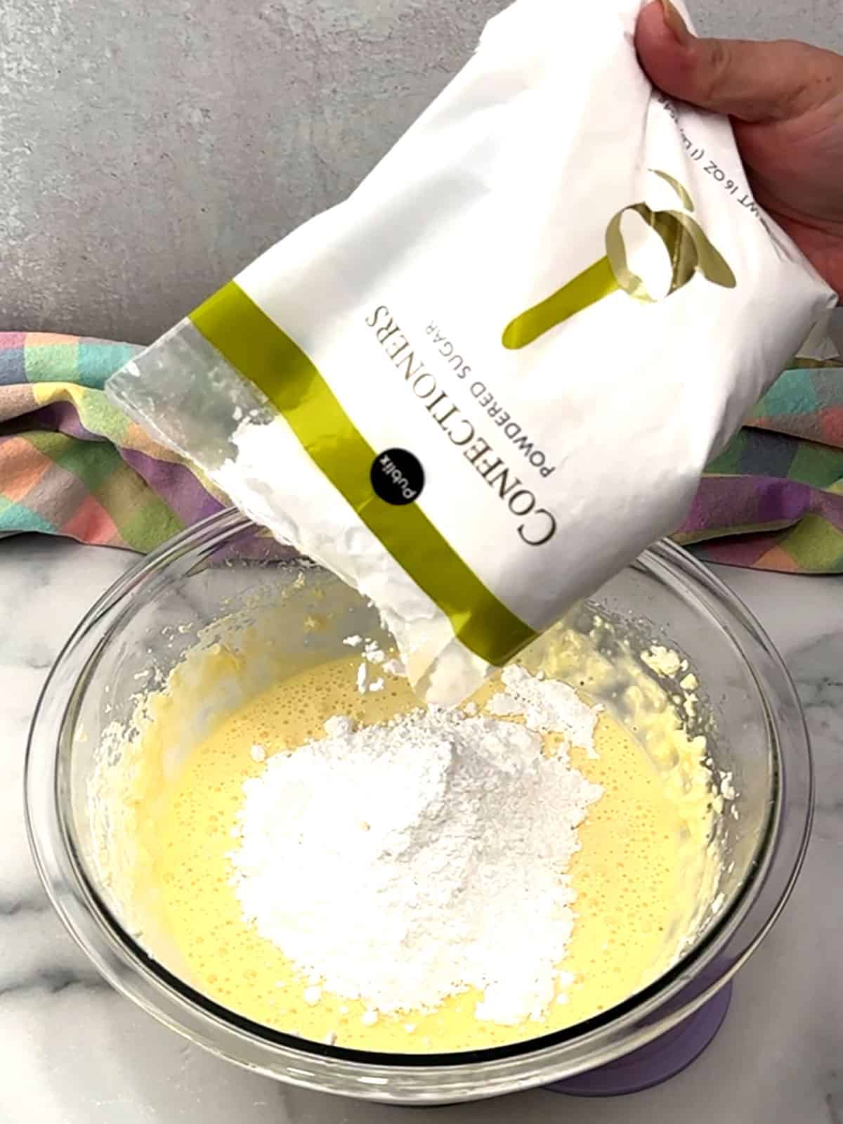 adding powdered sugar to cream cheese mixture