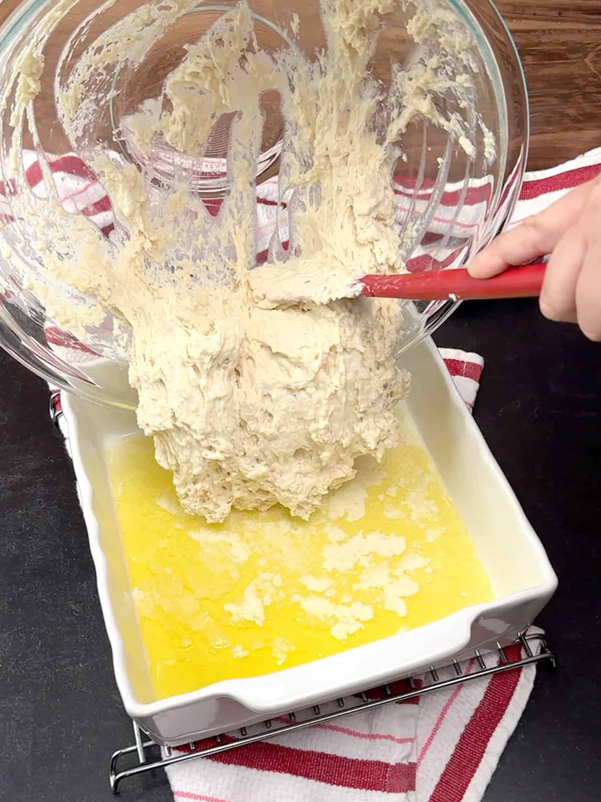 pouring dough into prepared dish