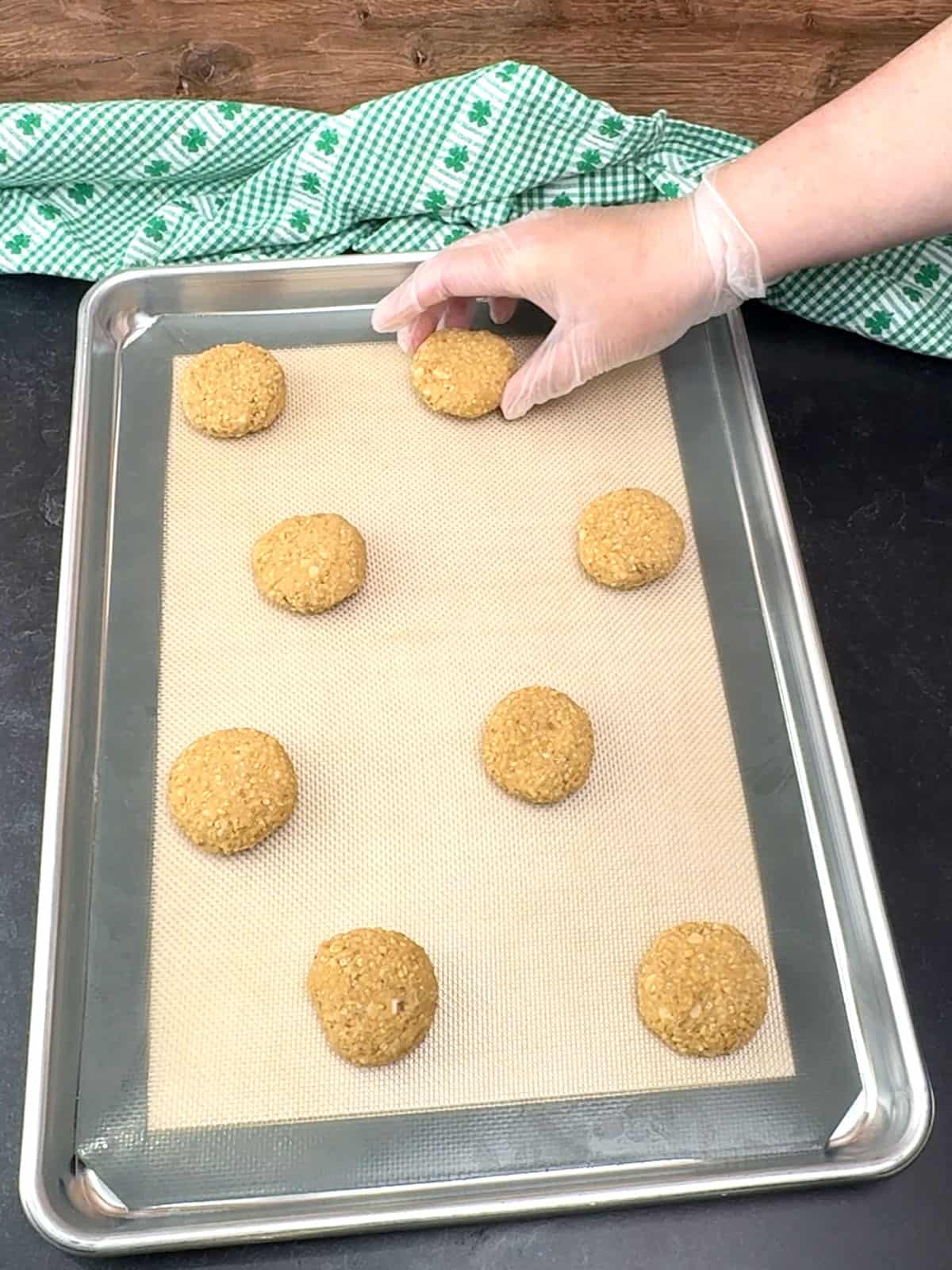 placing frozen Irish steel-cut oatmeal cookie dough disks on prepared pan