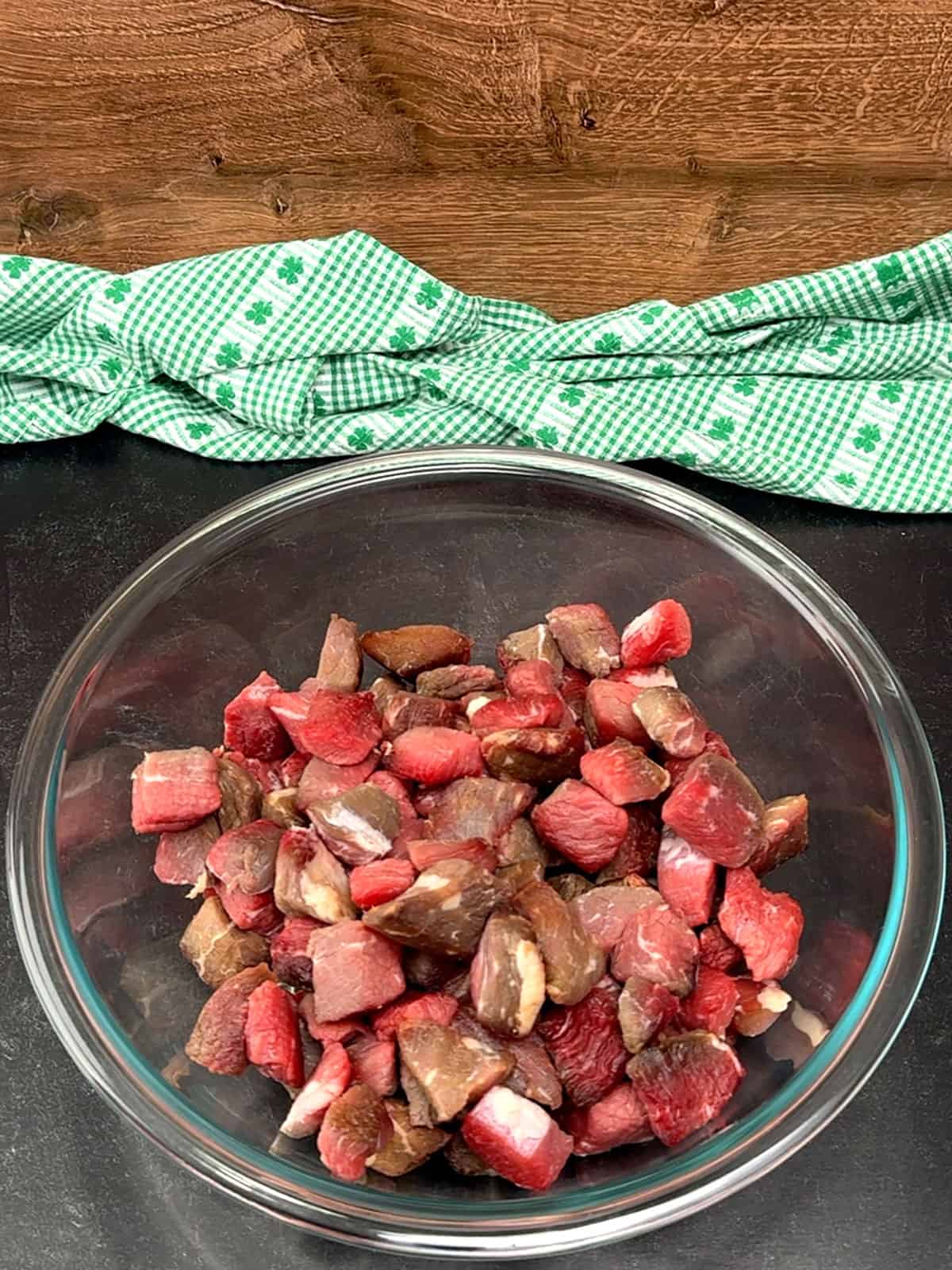 placing meat cubes in a large bowl