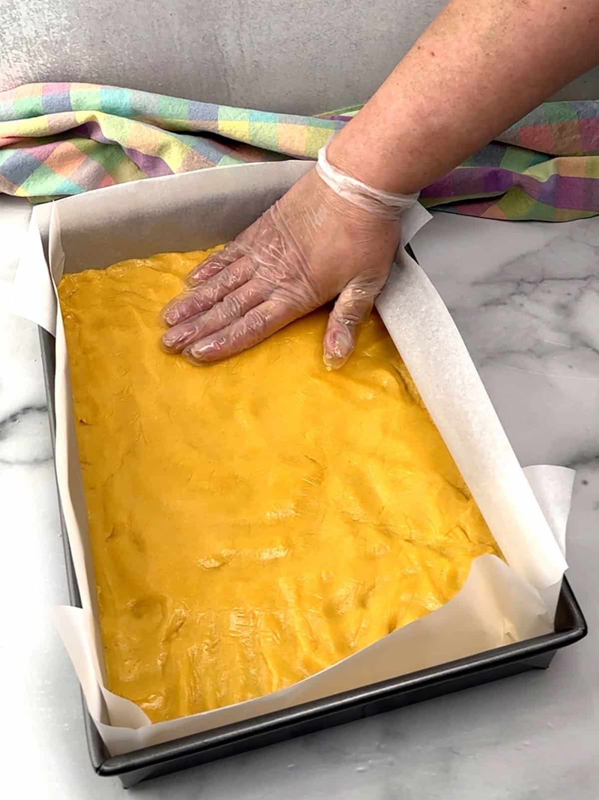 pressing dough into bottom of prepared pan