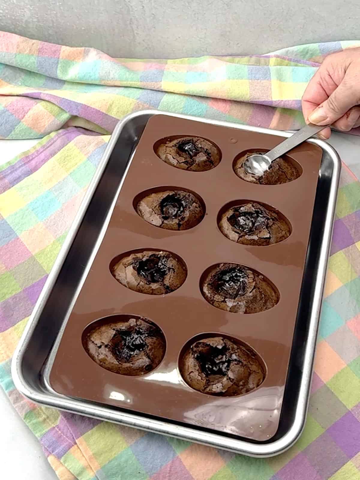 pressing indentation into the eggs