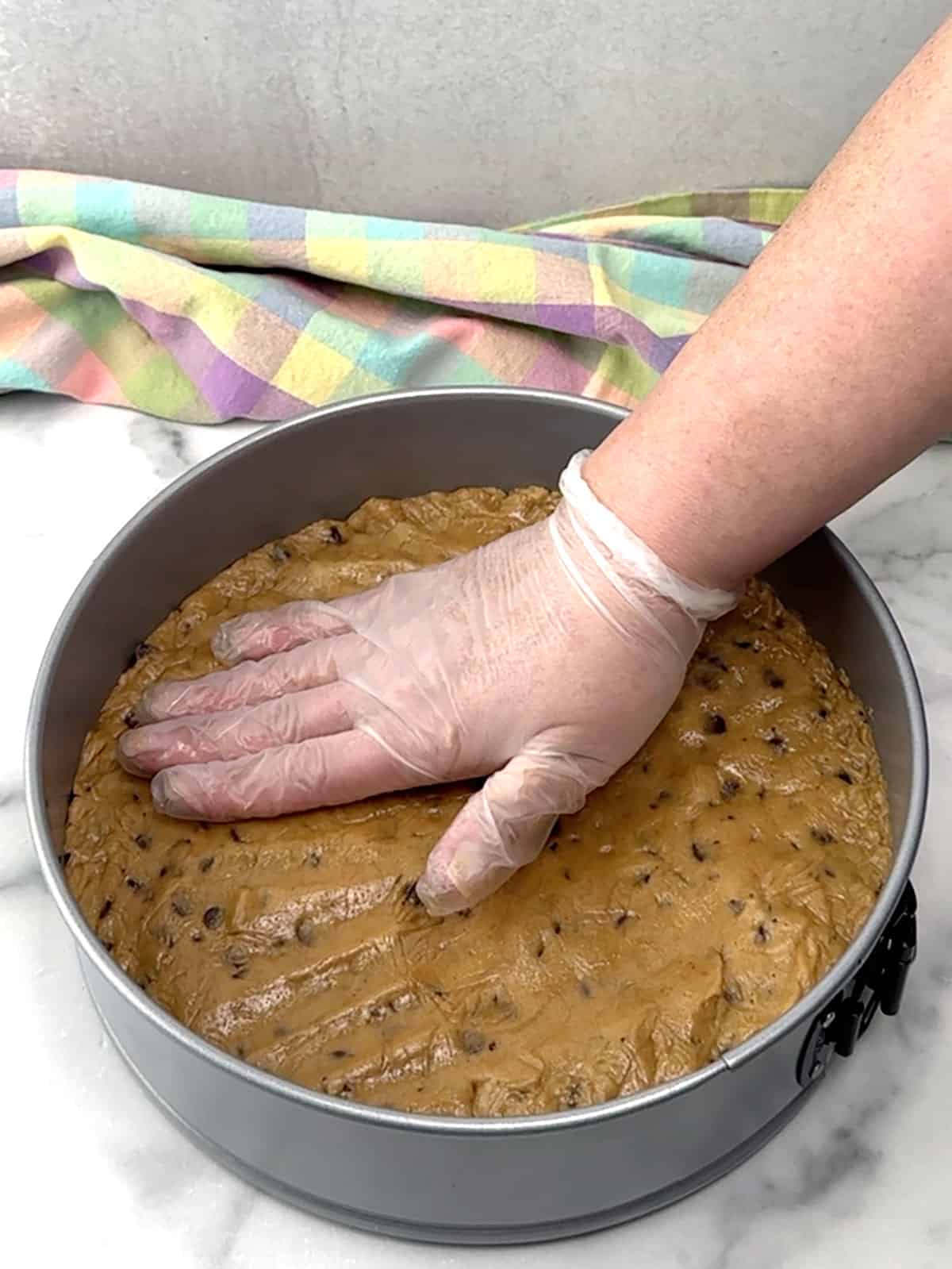 pressing cookie dough into pan