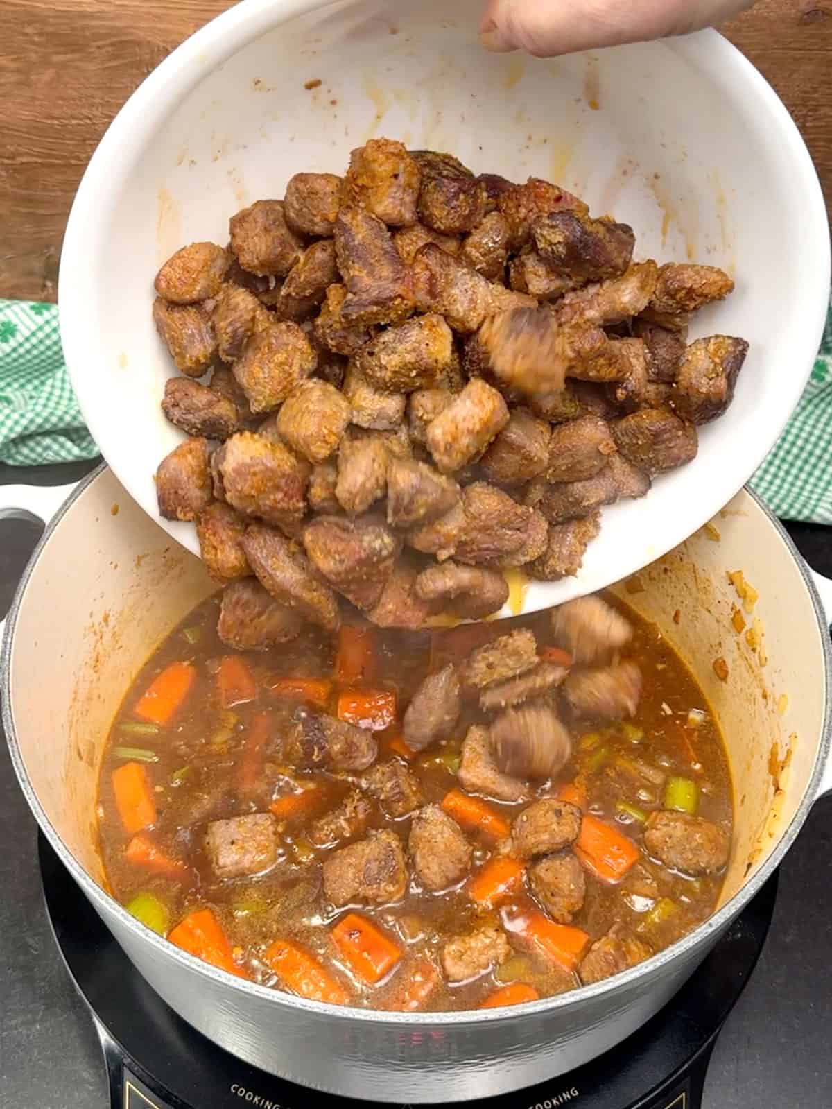 returning browned beef to pot