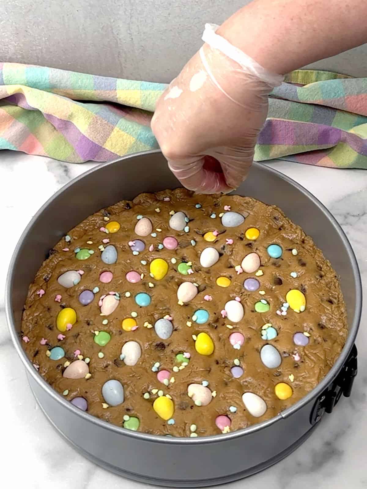 topping dough with easter candies and sprinkles