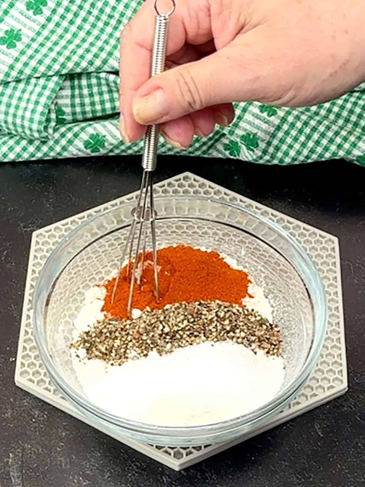 whisking flour, salt, pepper and paprika