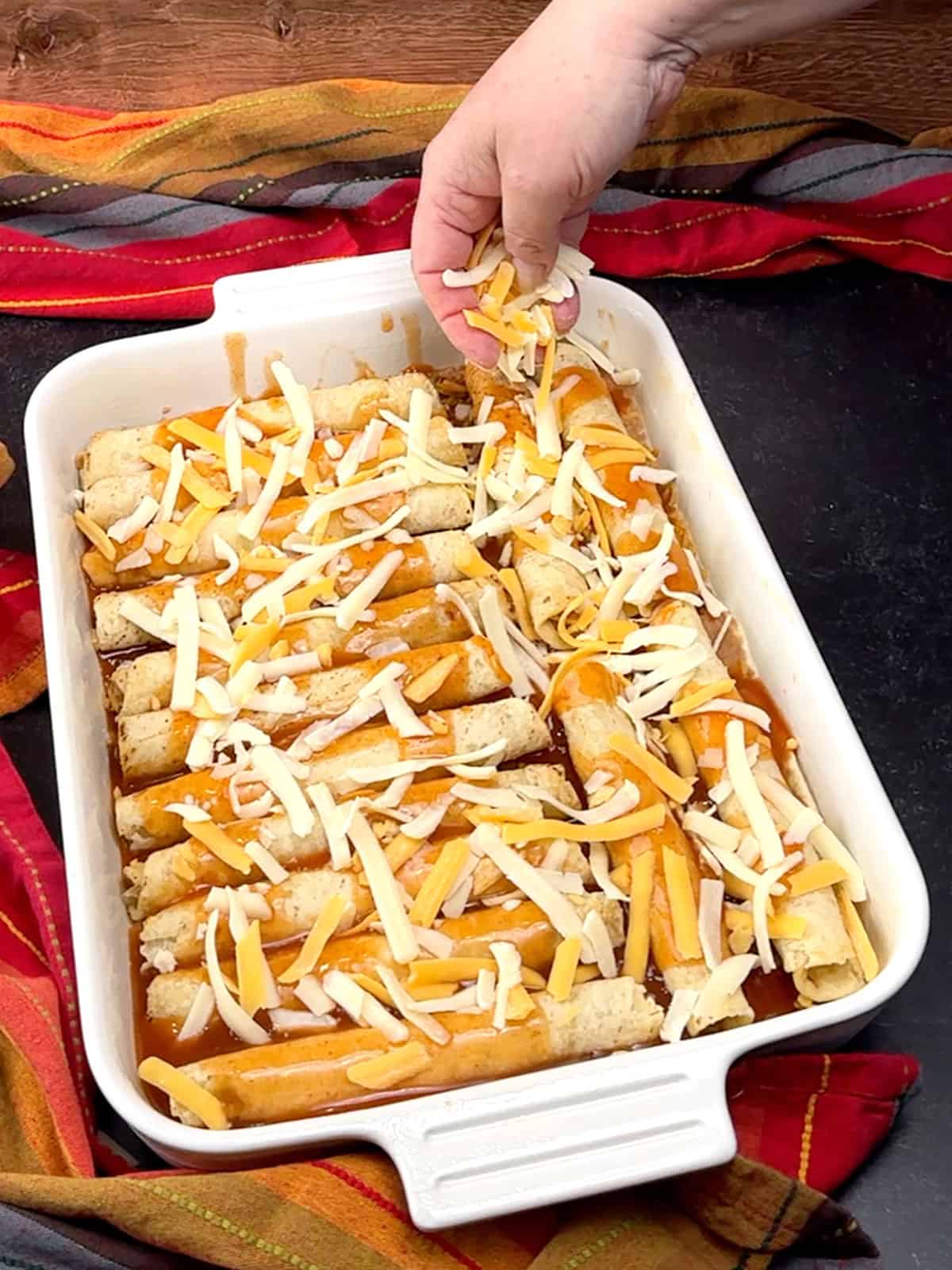 sprinkling first round of cheese before baking