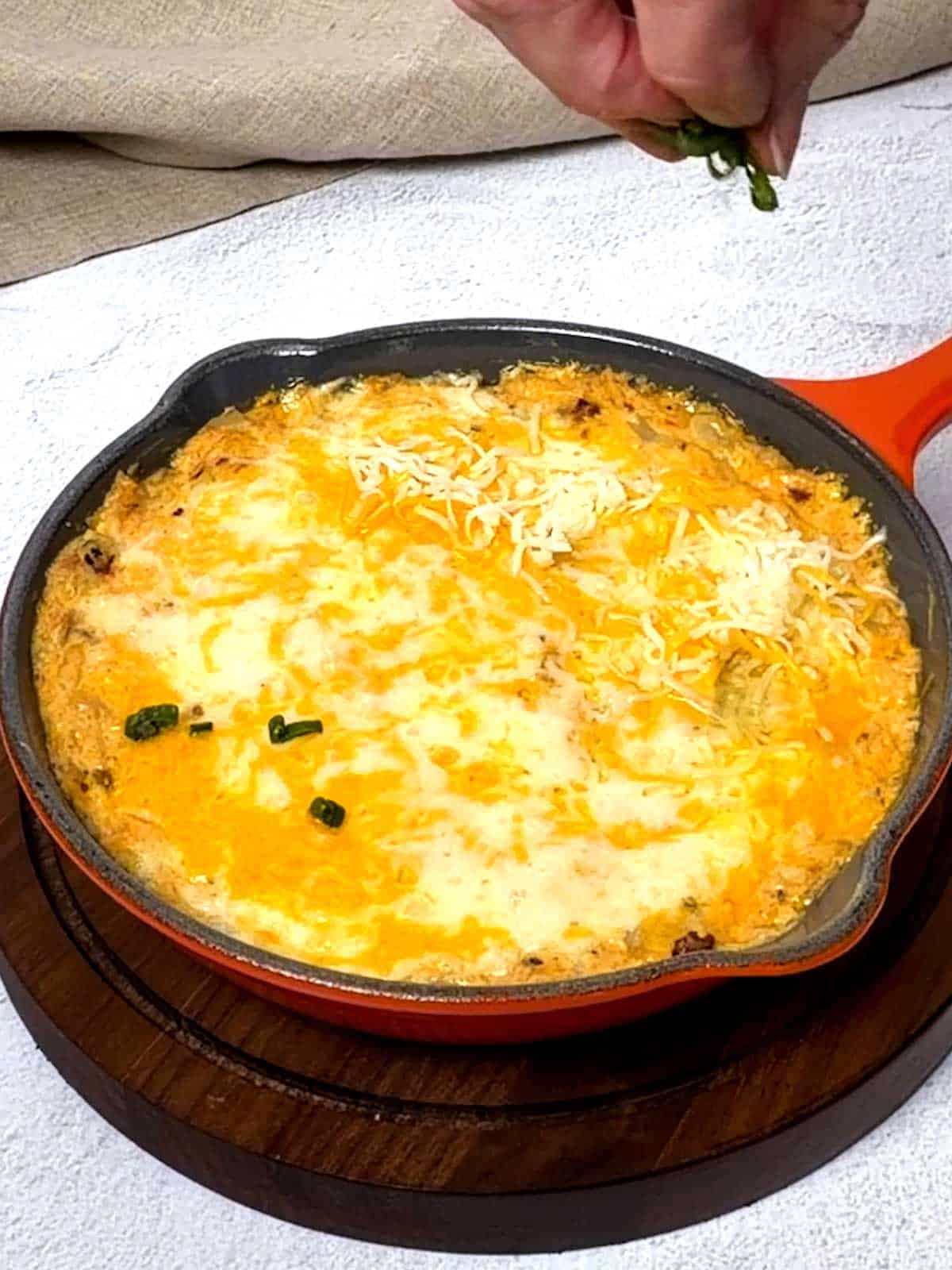 Adding sliced green onion tops.