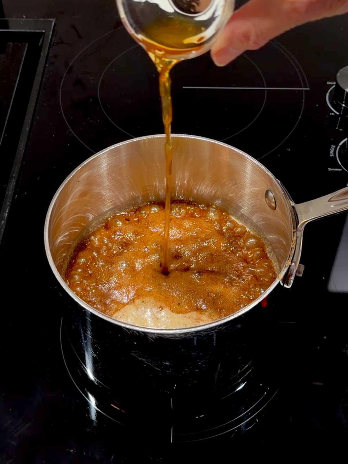 Adding vanilla to the caramel.
