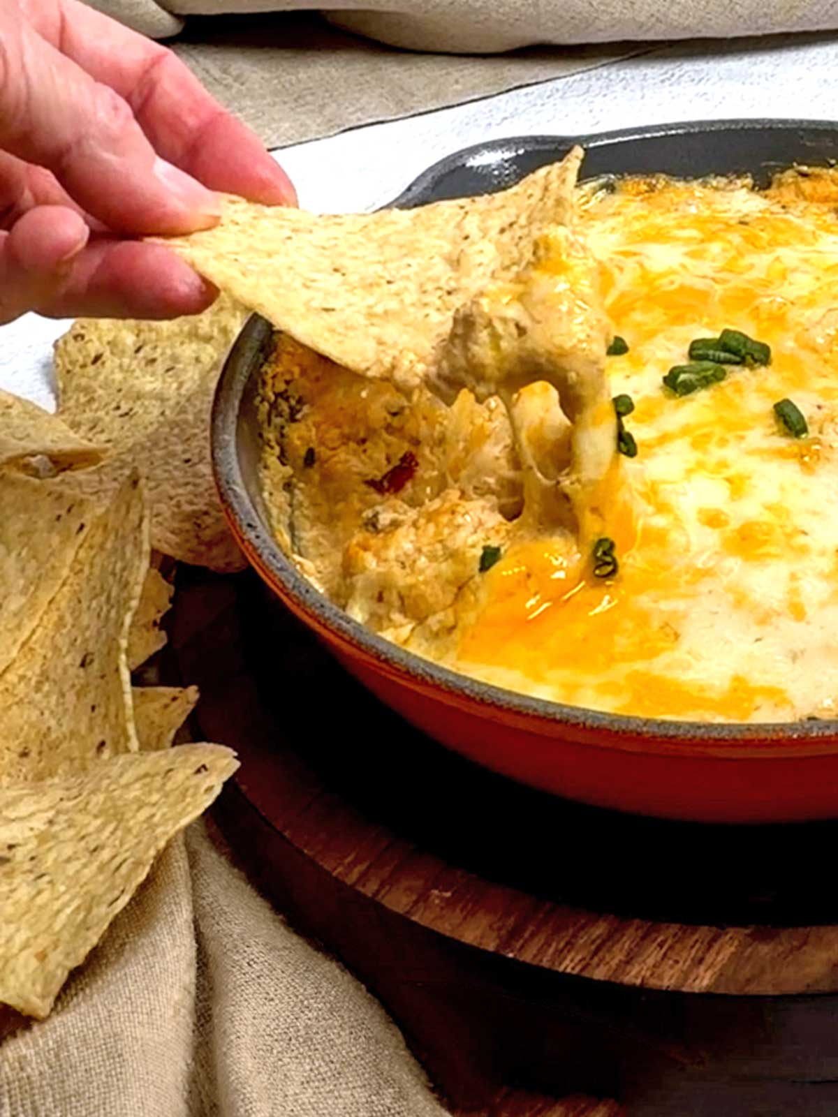 Cheese pull with a tortilla chip.