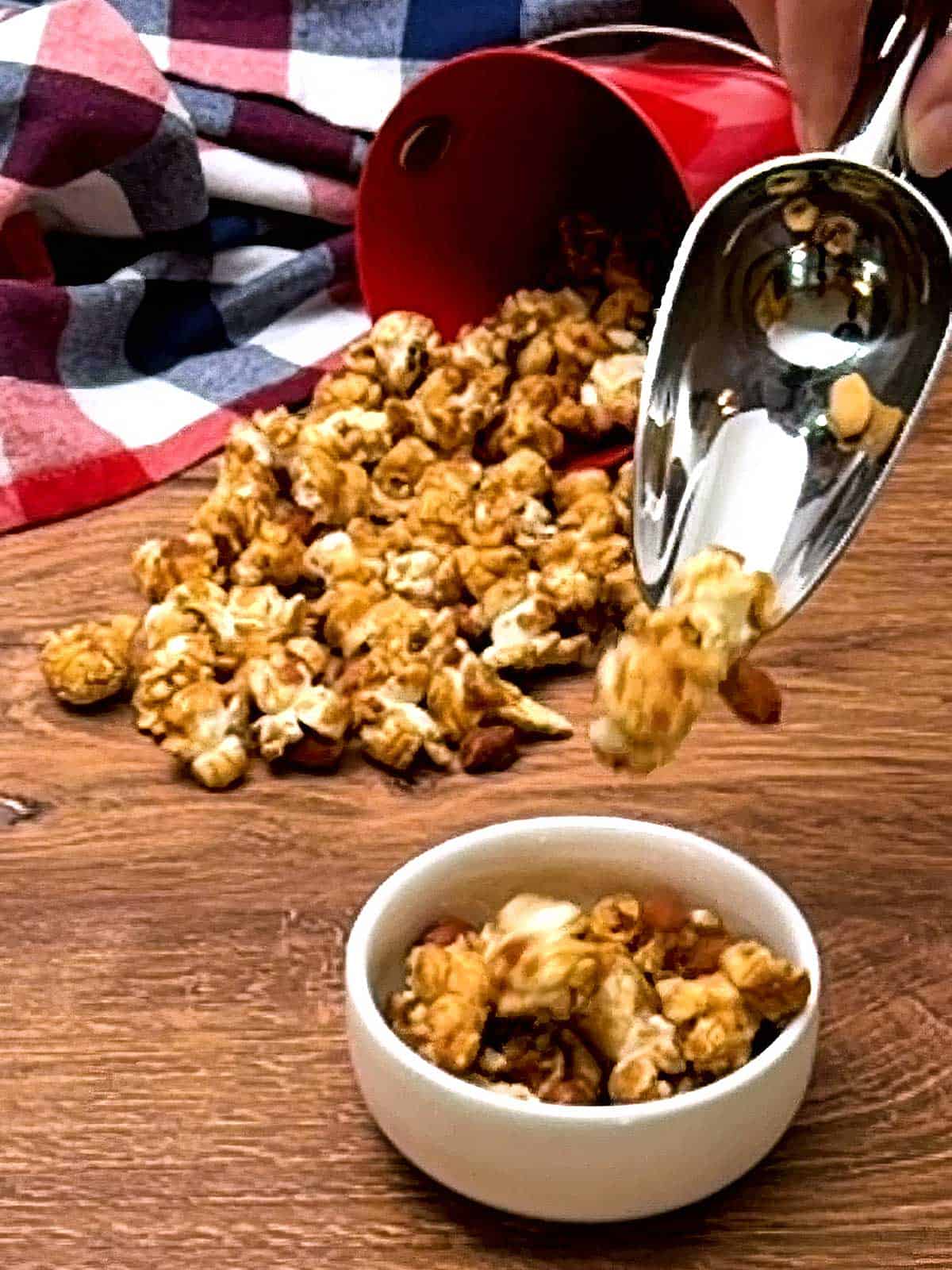Adding caramel corn to a small dish.