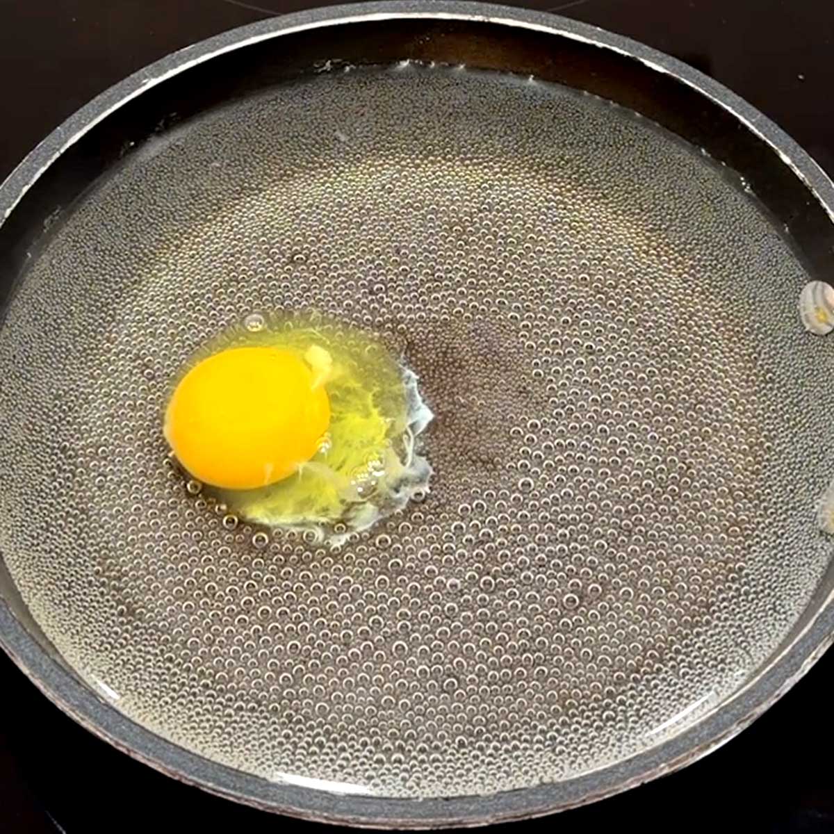 Poaching the egg with the spoon method.