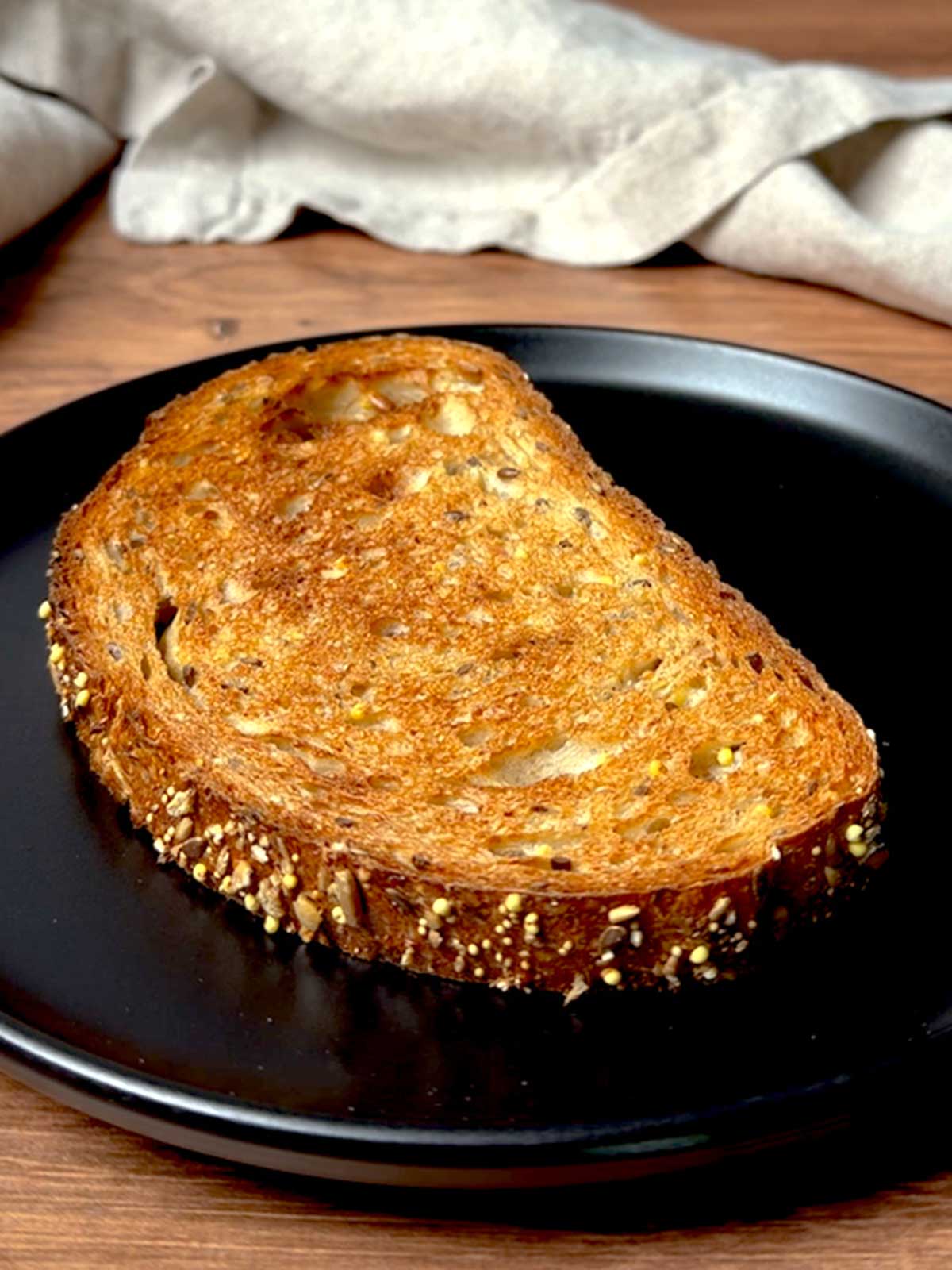Toast on a black plate.