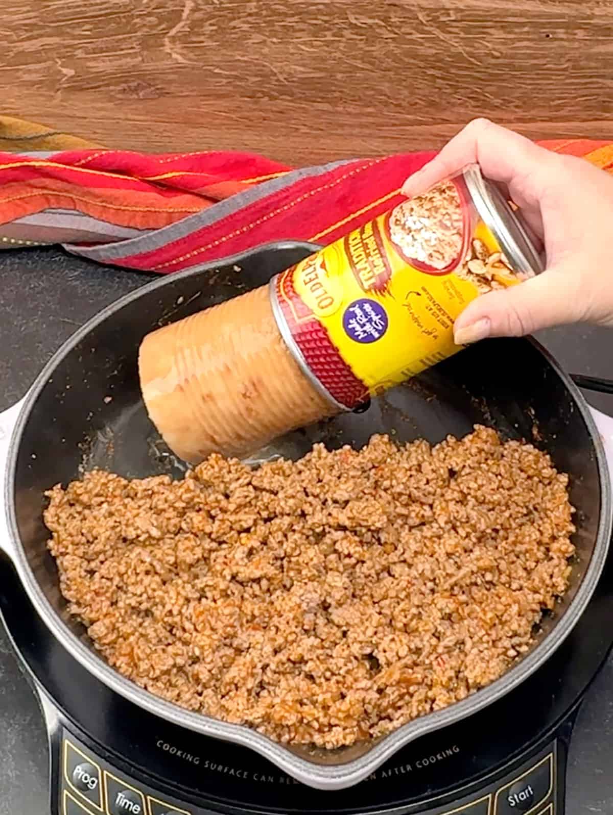 adding refried beans to meat