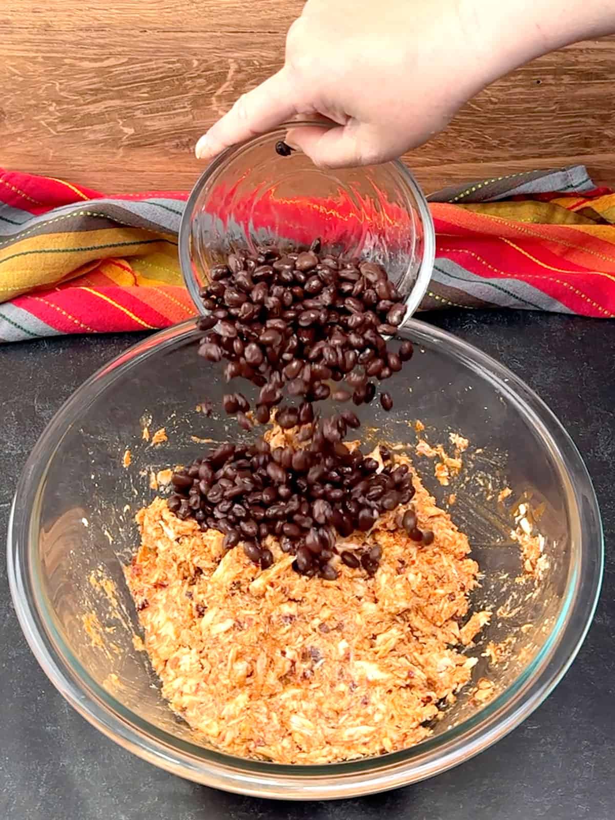 adding black beans to chicken mixture