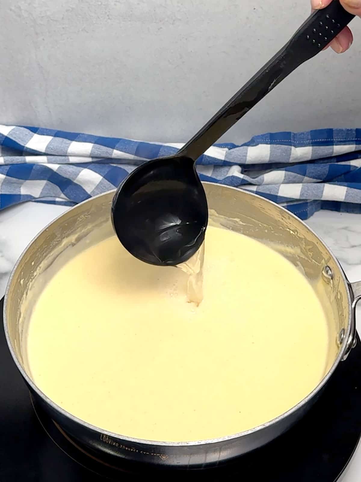 adding reserved water to cheese sauce