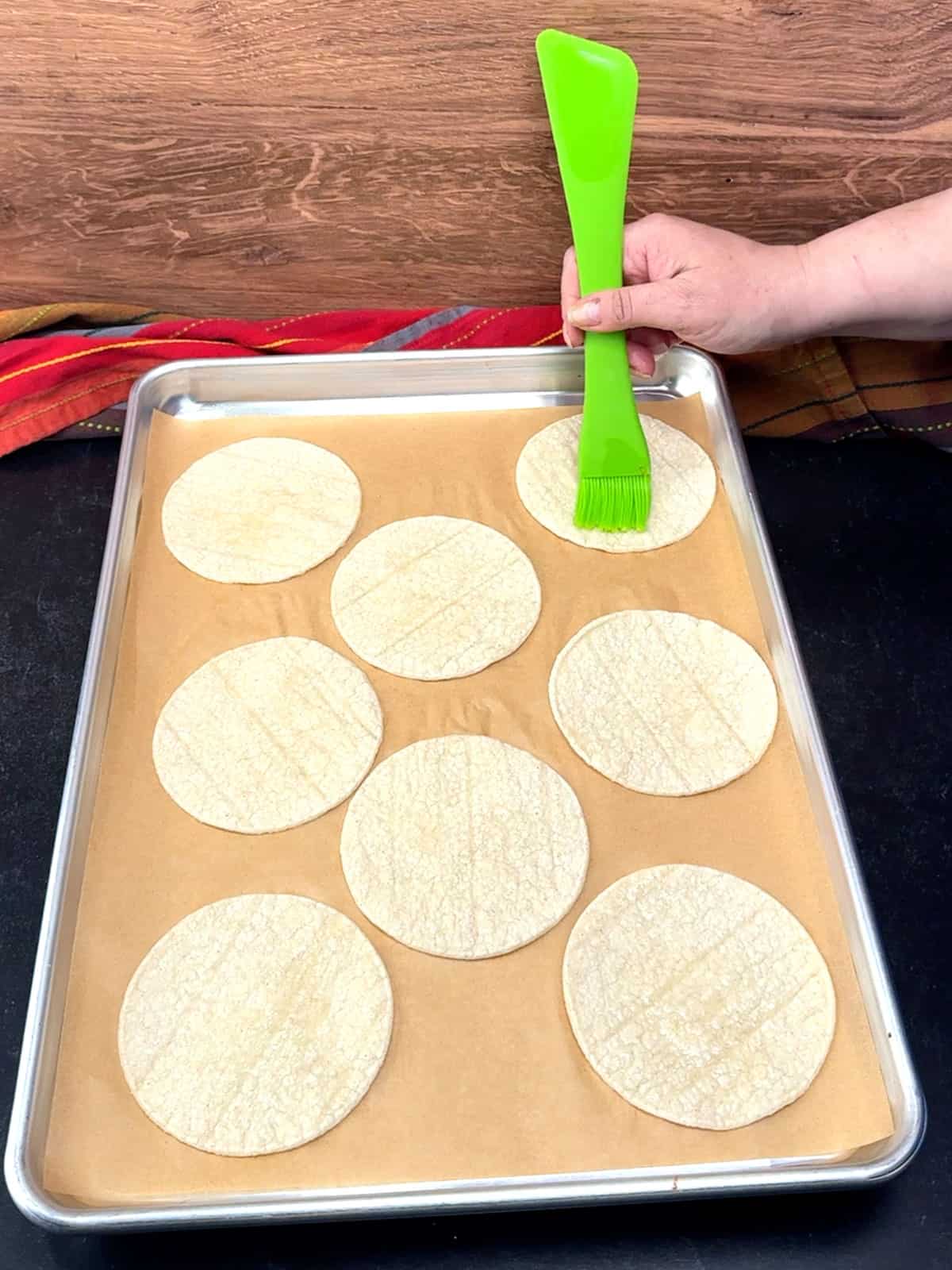 brushing warmed tortillas with olive oil