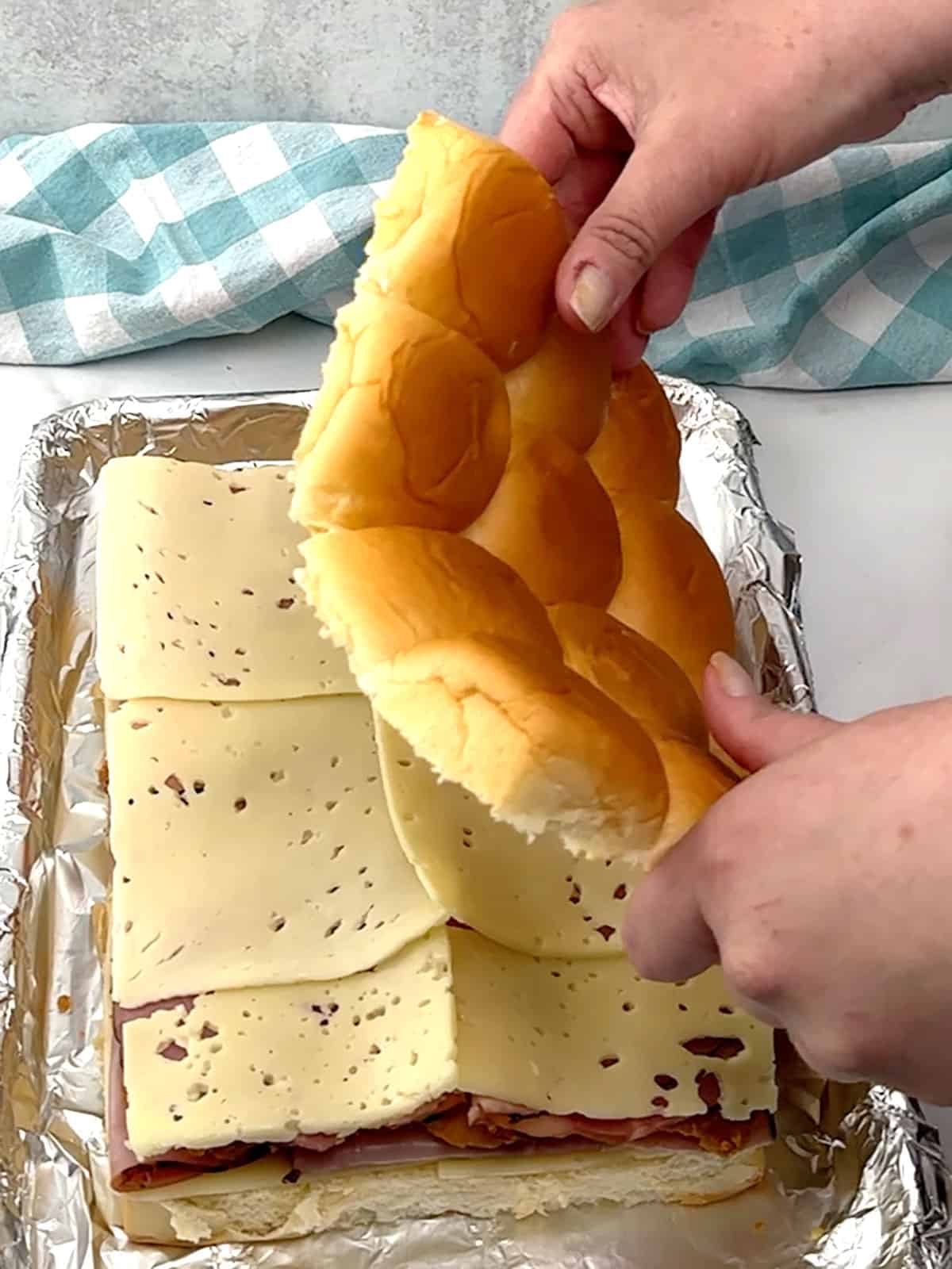 placing the buns on top of the cheese