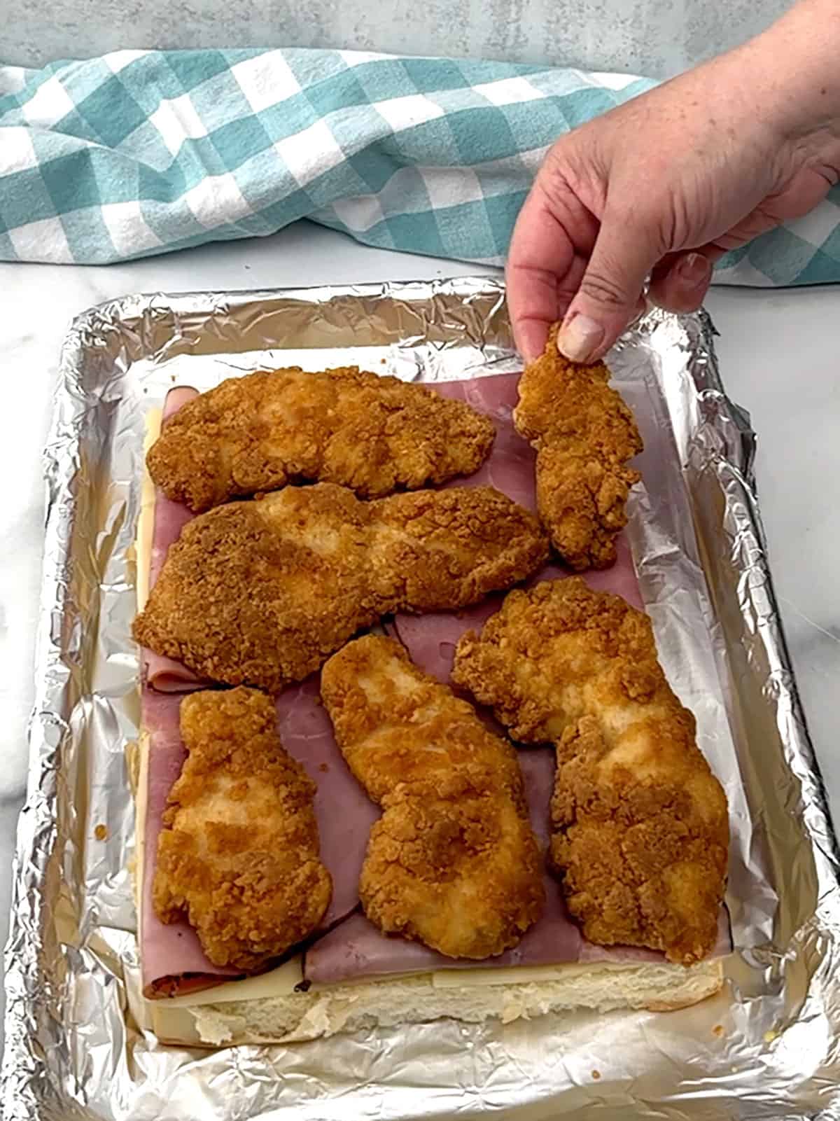 cooked chicken tenders on top of ham slices