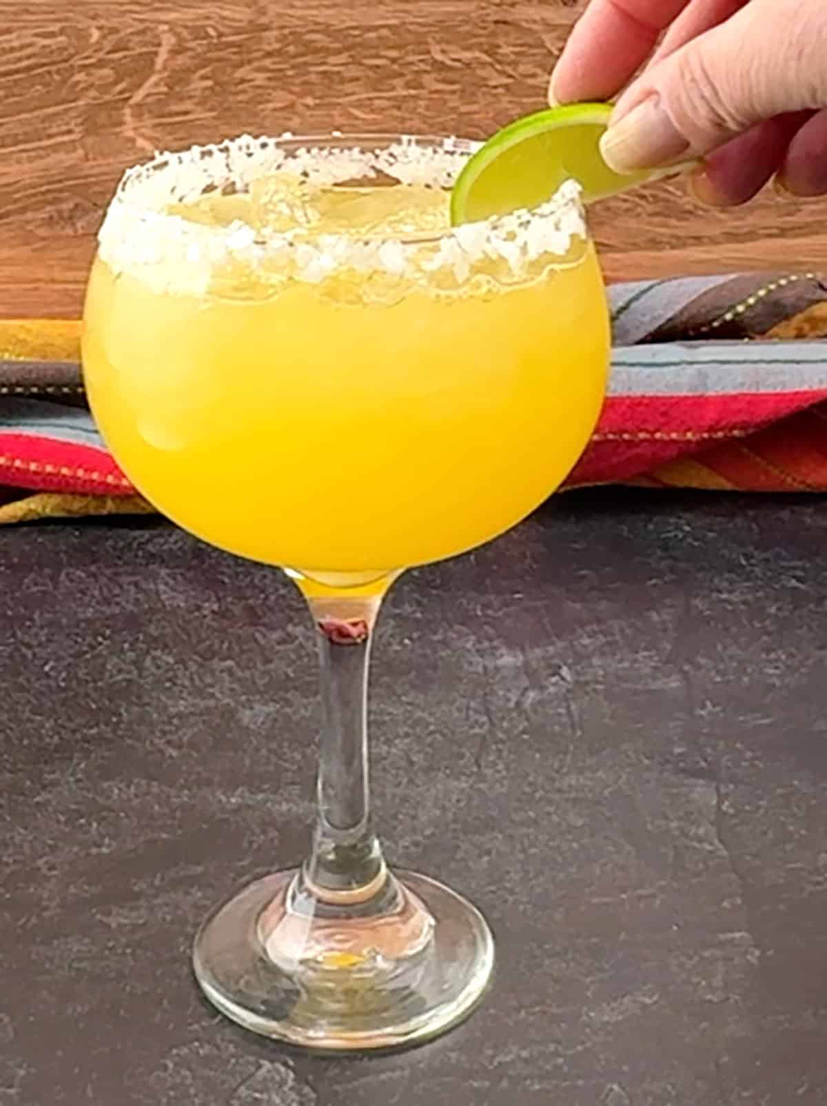 lime wedge on rim of filled glass