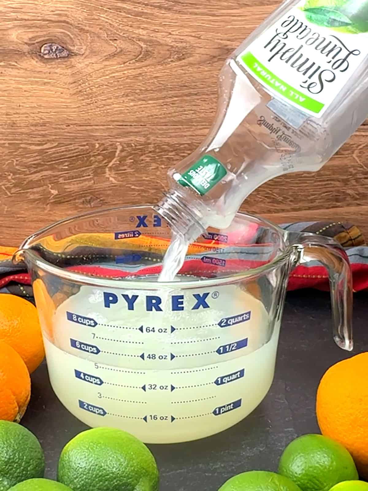 pouring limeade into measuring cup