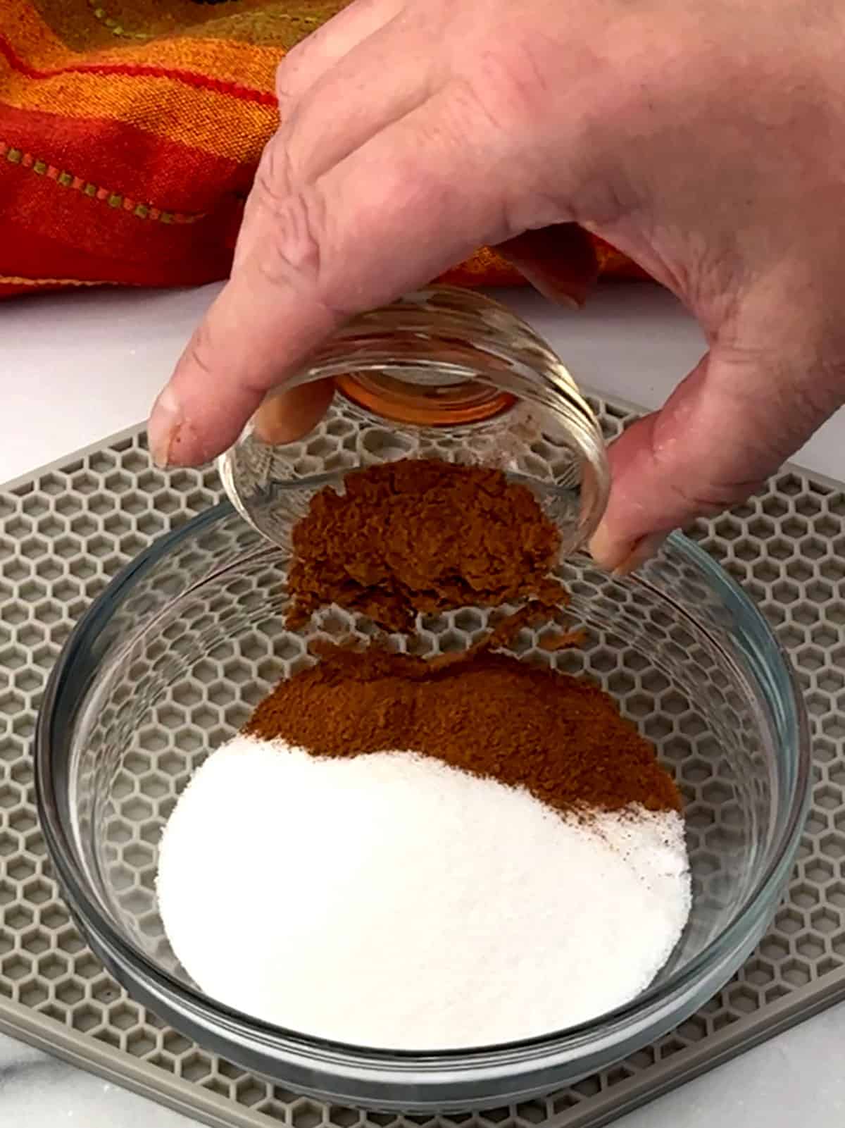 combining sugar and cinnamon for topping