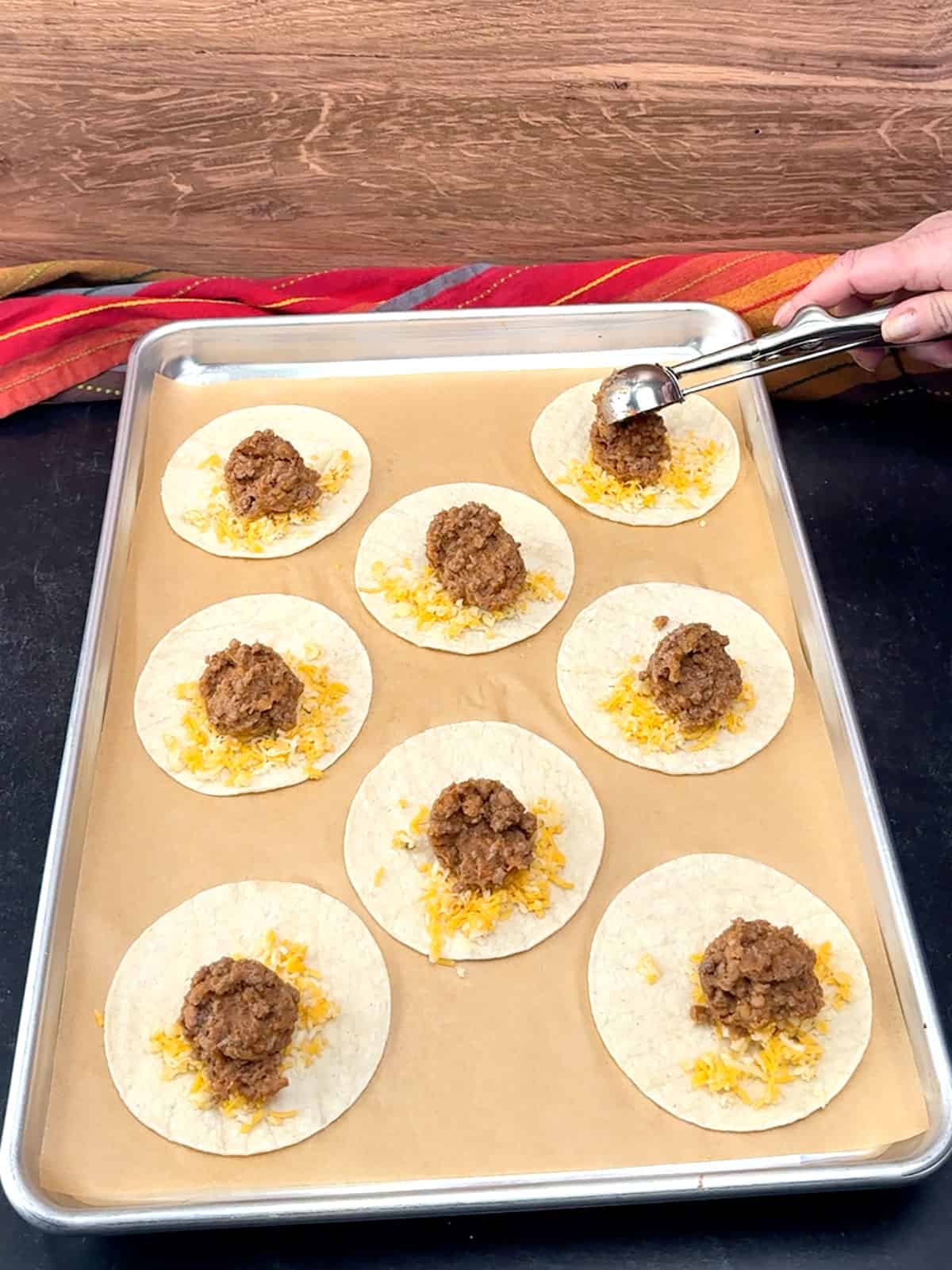 scooping meat onto tortillas