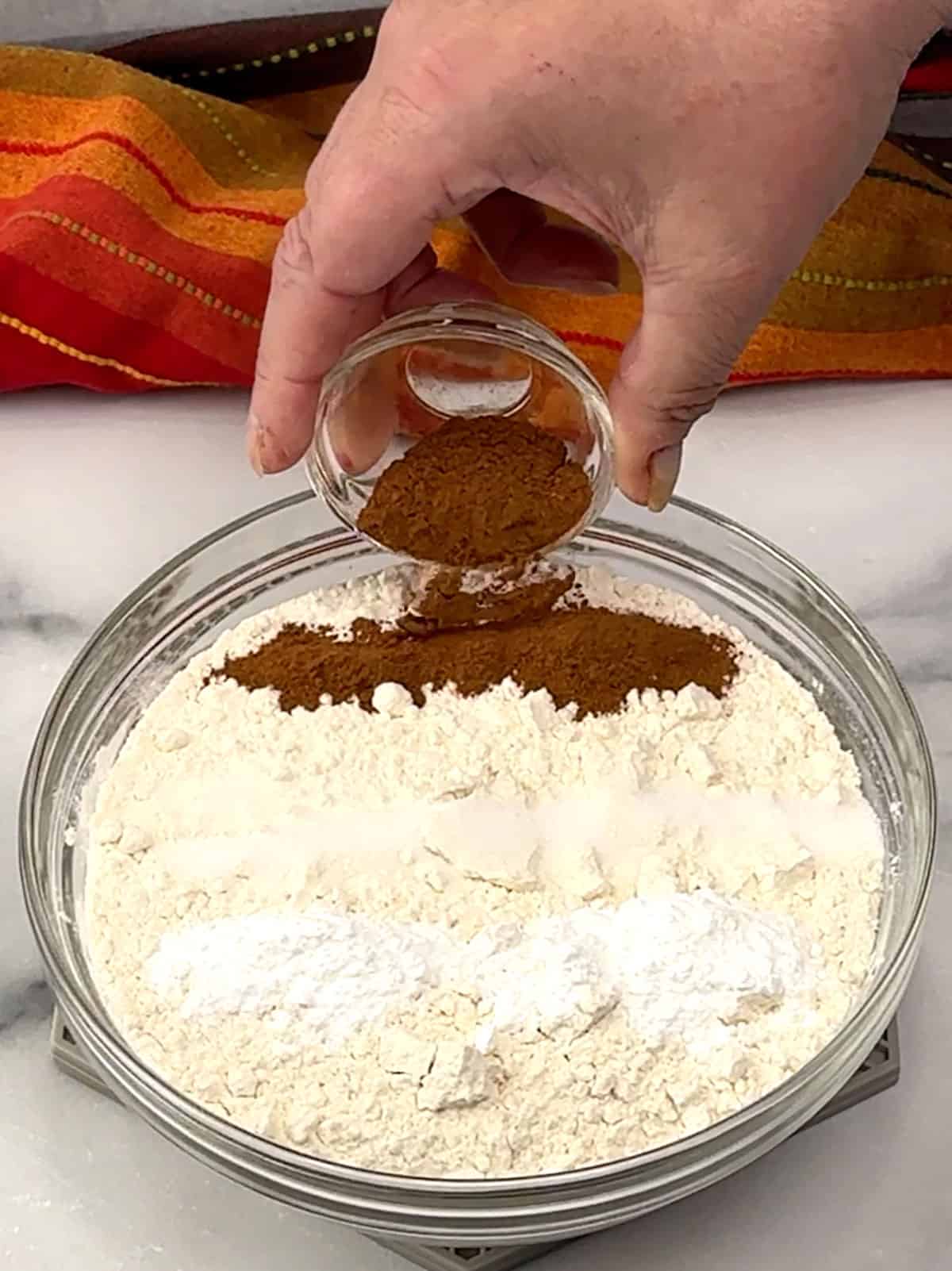 combining flour, salt, baking powder, and cinnamon in a small bowl