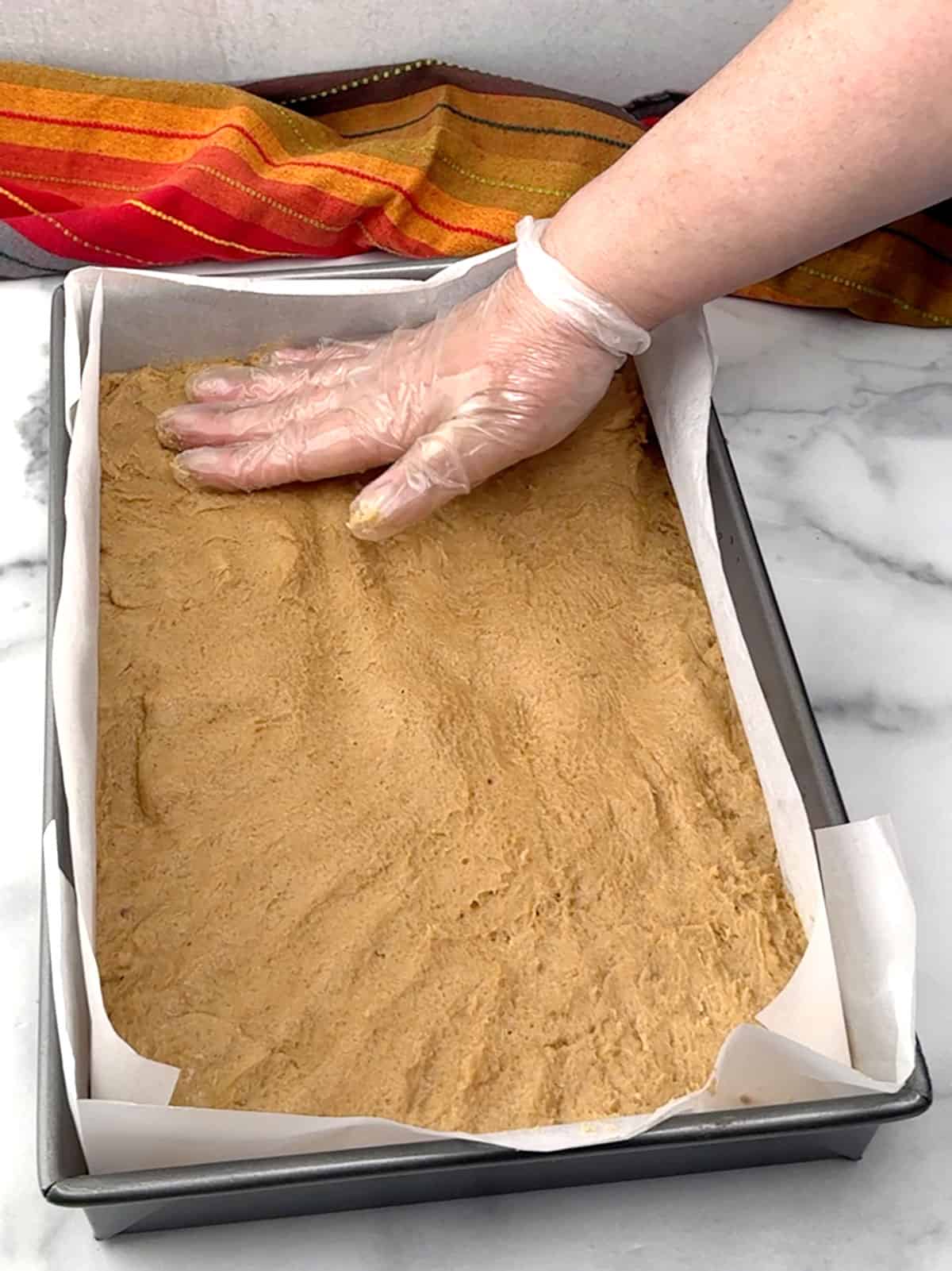 pressing batter into pan