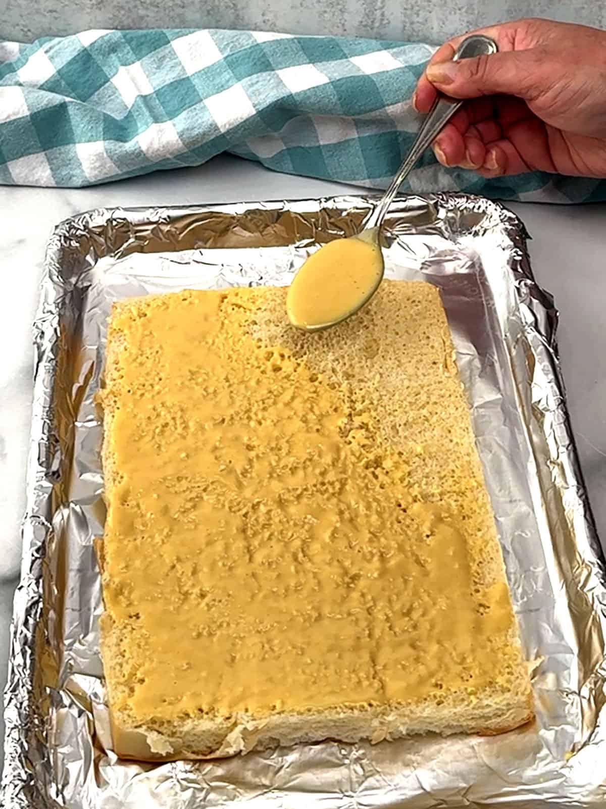 spreading sauce on bottom buns