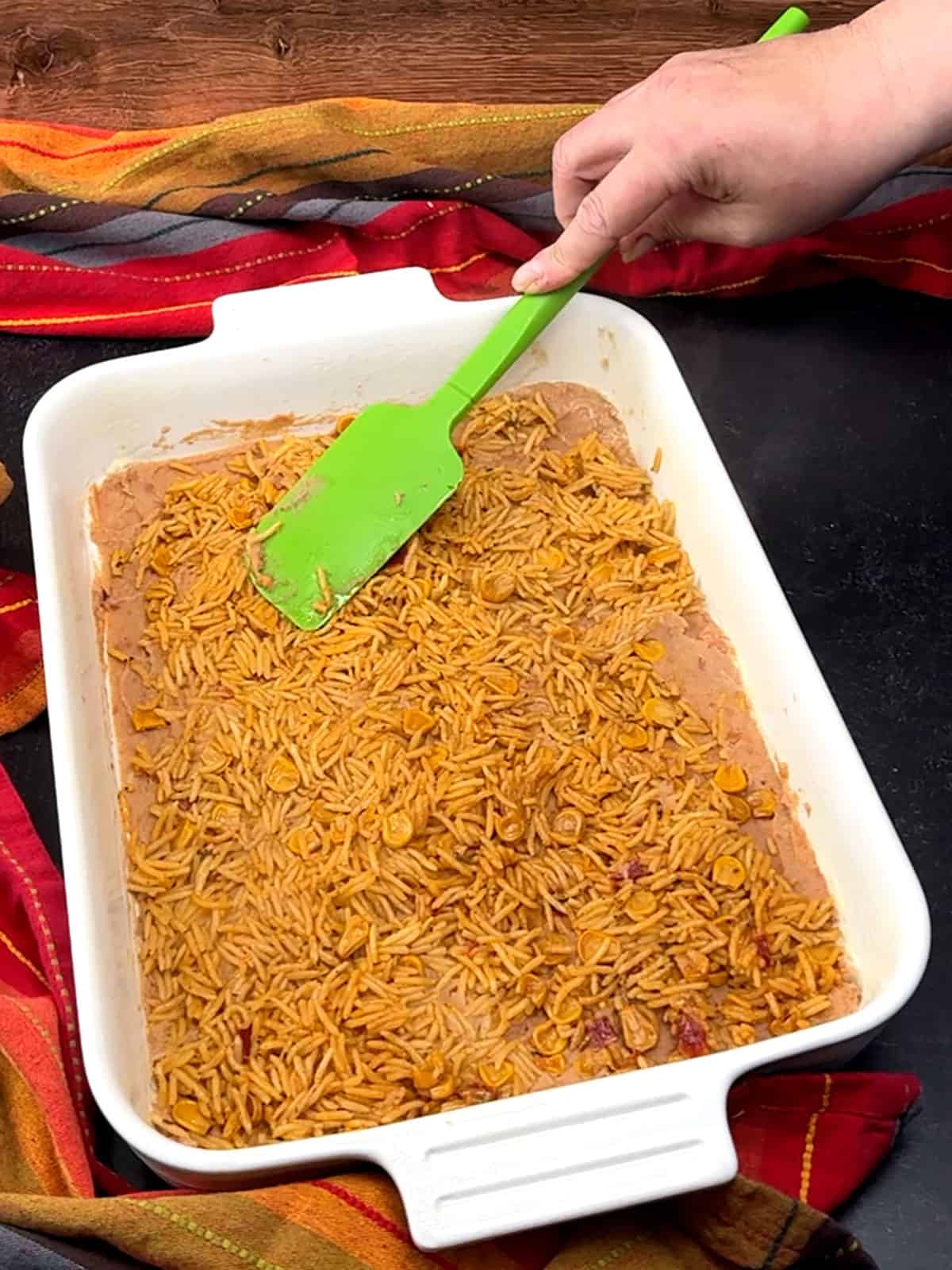 spreading rice over beans