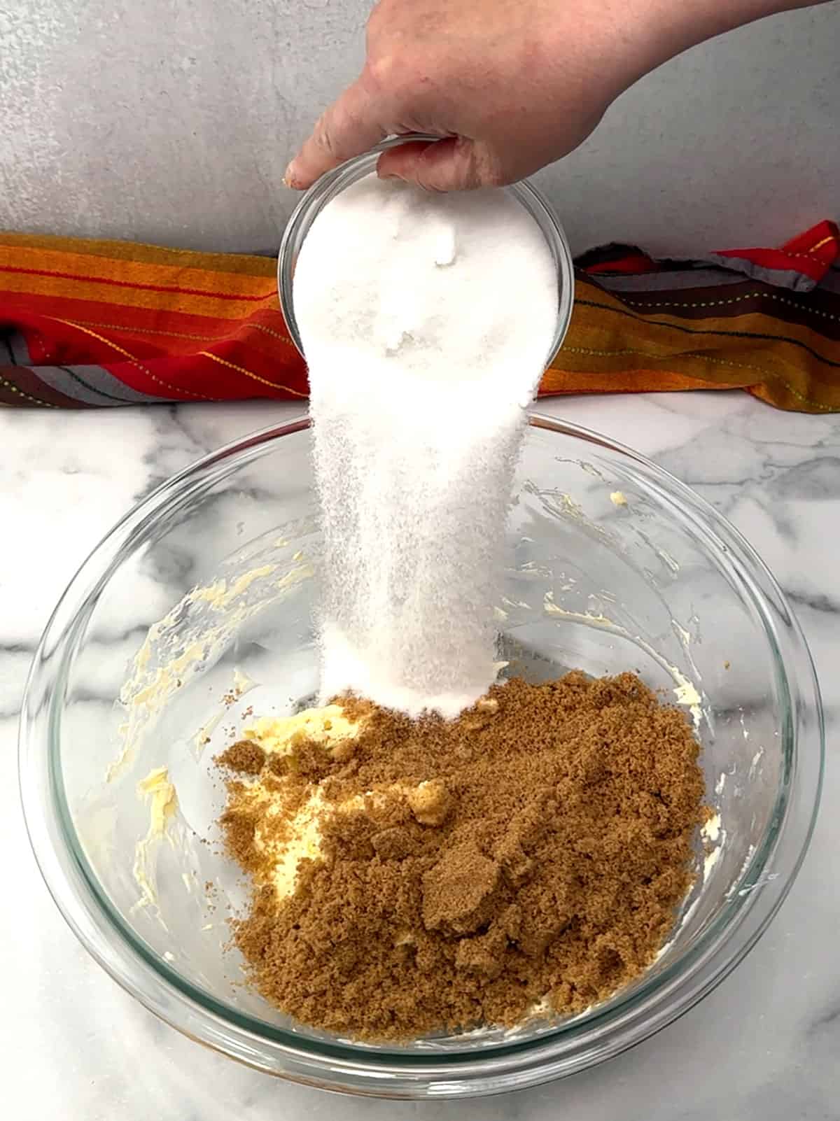 adding sugars to beaten butter