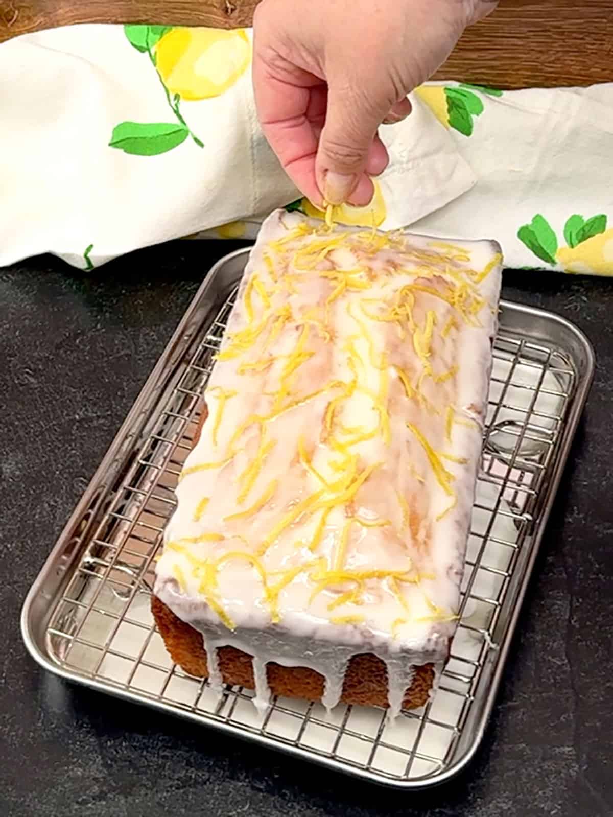 sprinkling lemon zest over the top of the Better Then Starbucks Lemon Loaf
