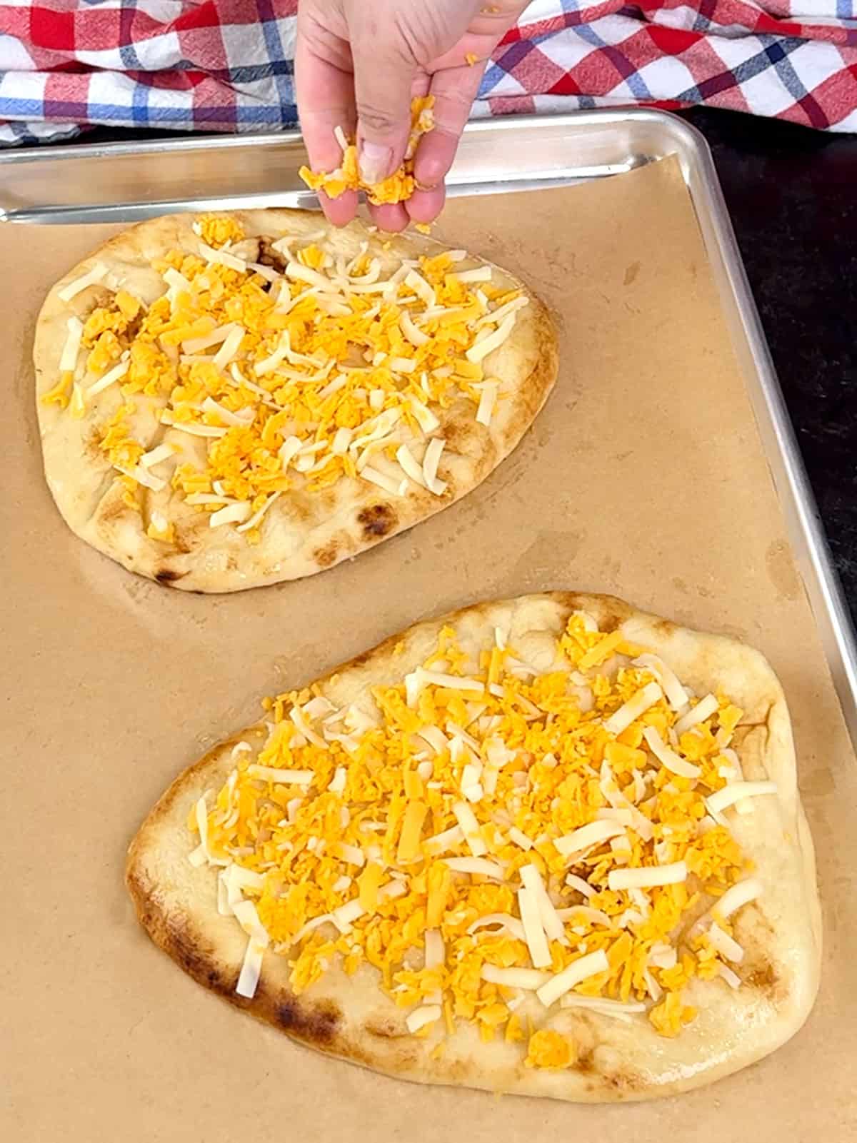 sprinkling first layer of cheese