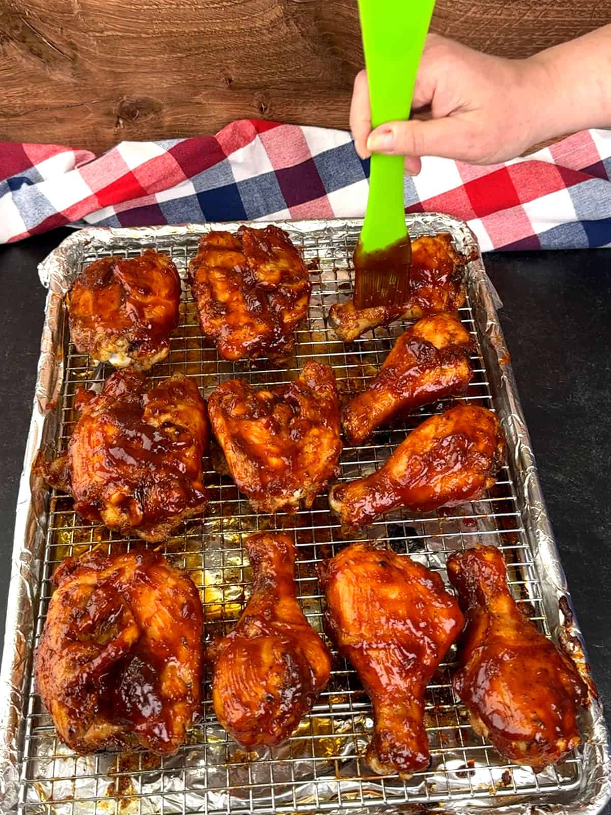 brushing chicken with second round of sauce